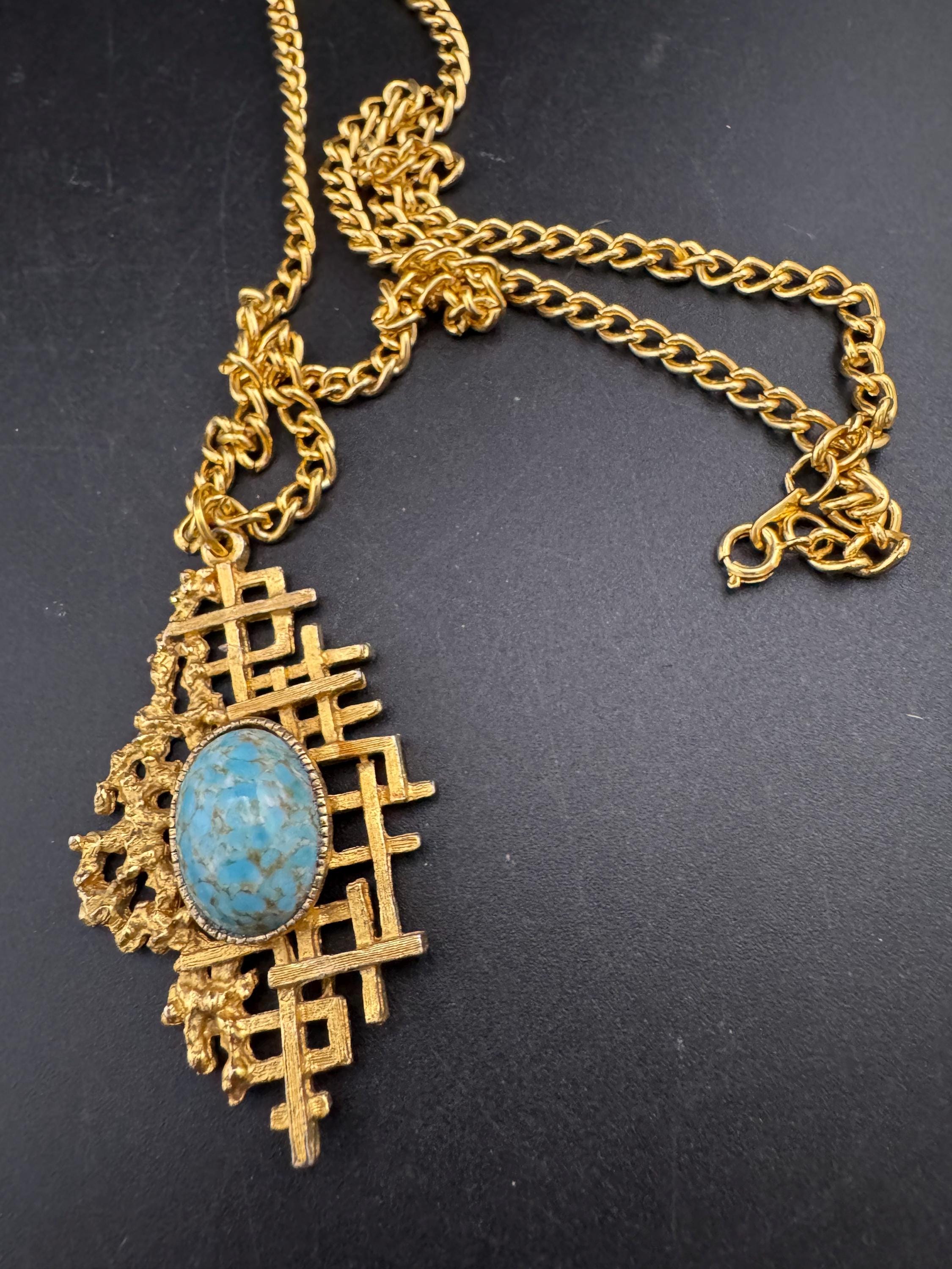 Vintage gold tone brutalist pendant with faux turquoise oval cabochon