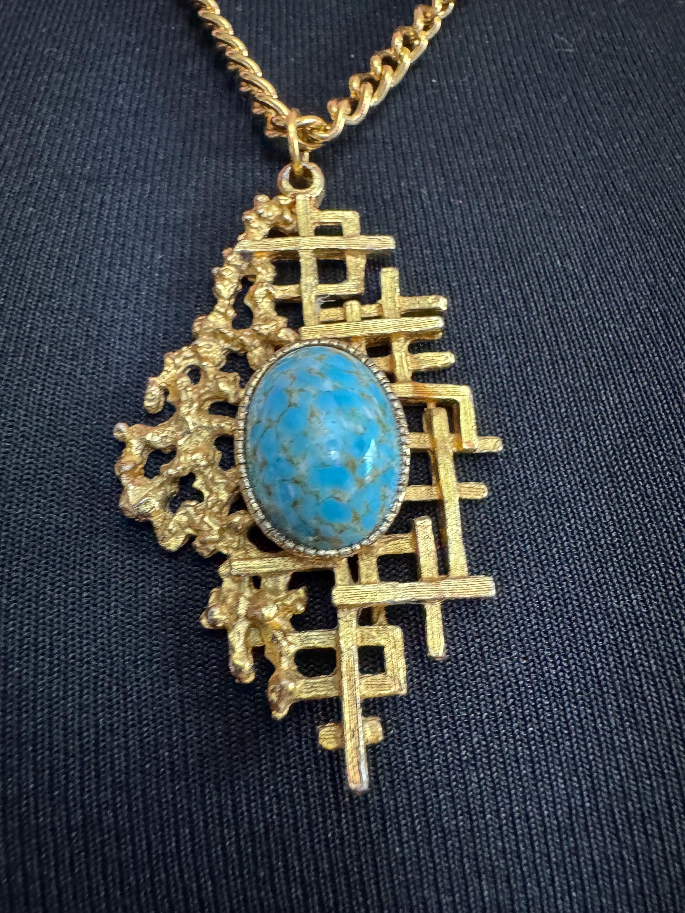 Vintage gold tone brutalist pendant with faux turquoise oval cabochon