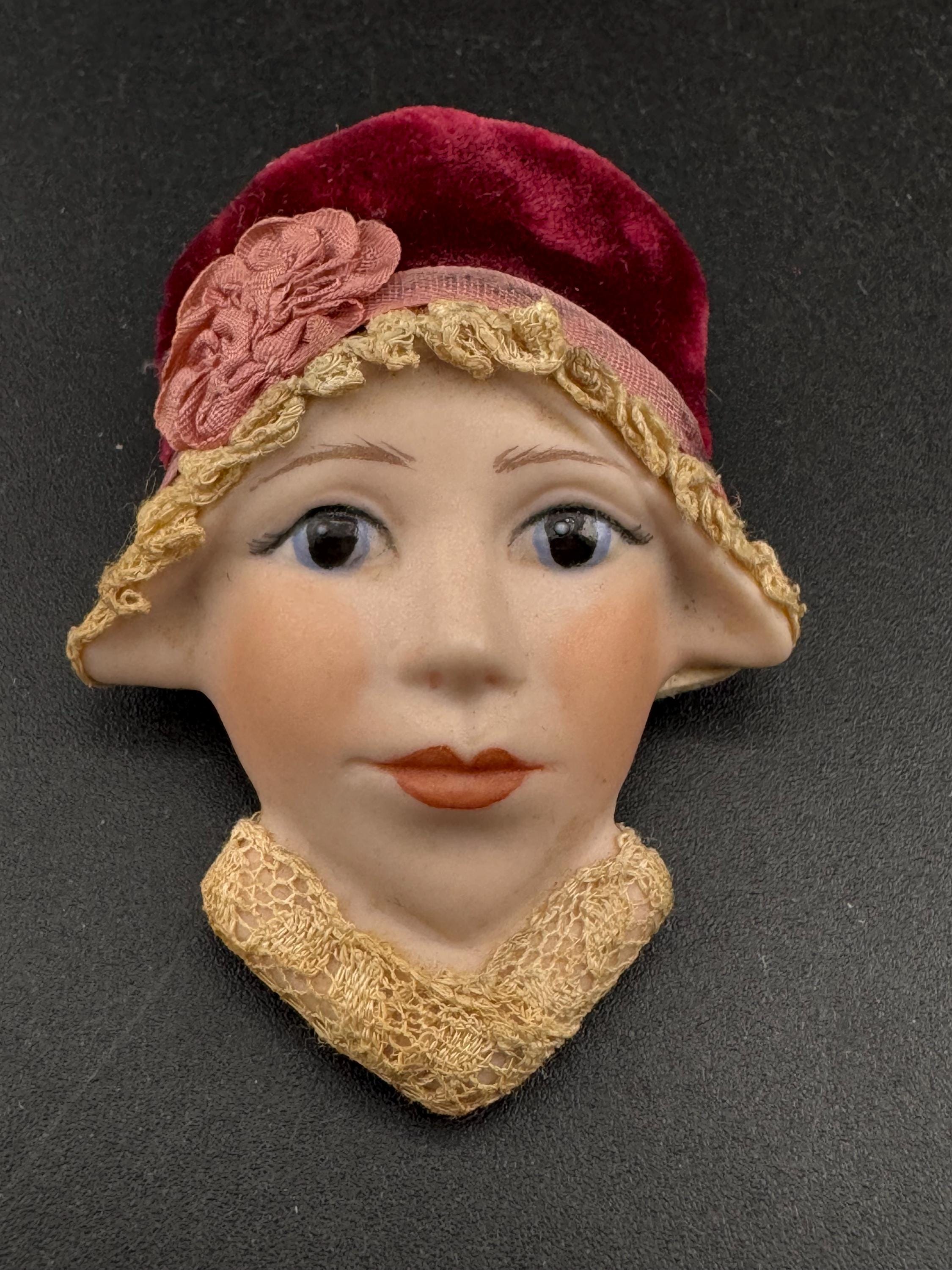 Vintage ceramic flapper face brooch: art deco with red velvet hat