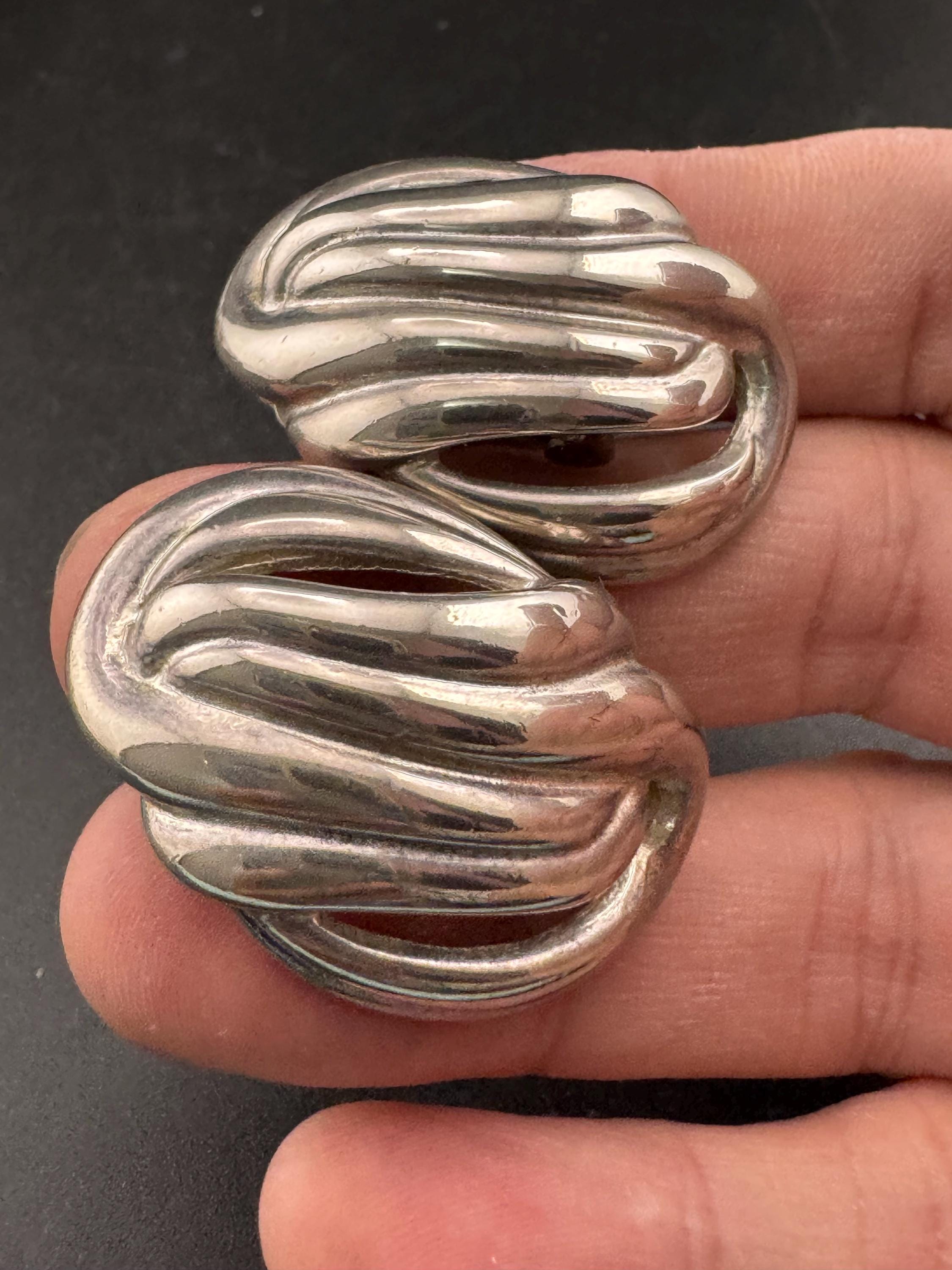 Vintage oversized silver metal swirl clip on earrings, 1980s