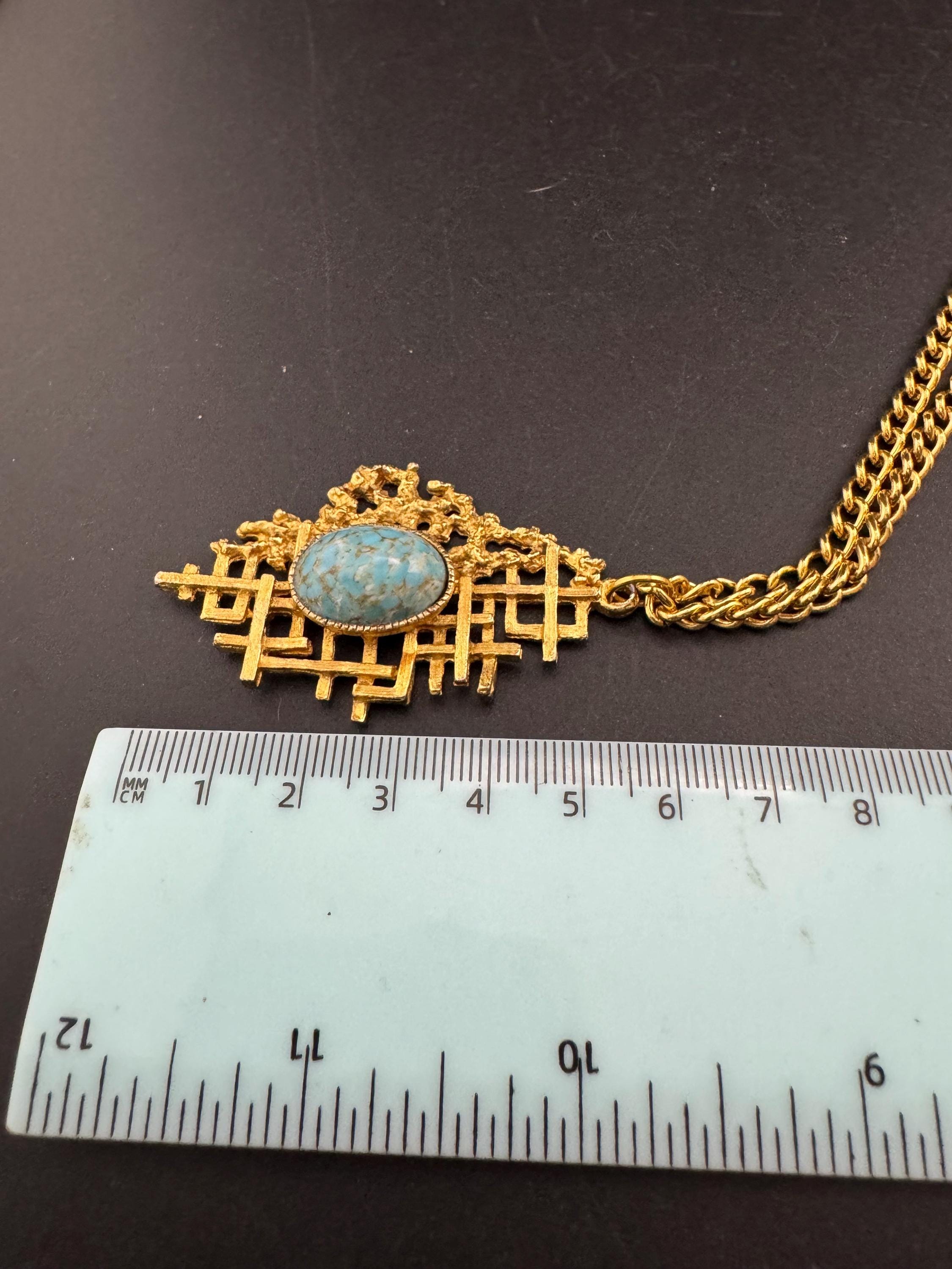 Vintage gold tone brutalist pendant with faux turquoise oval cabochon