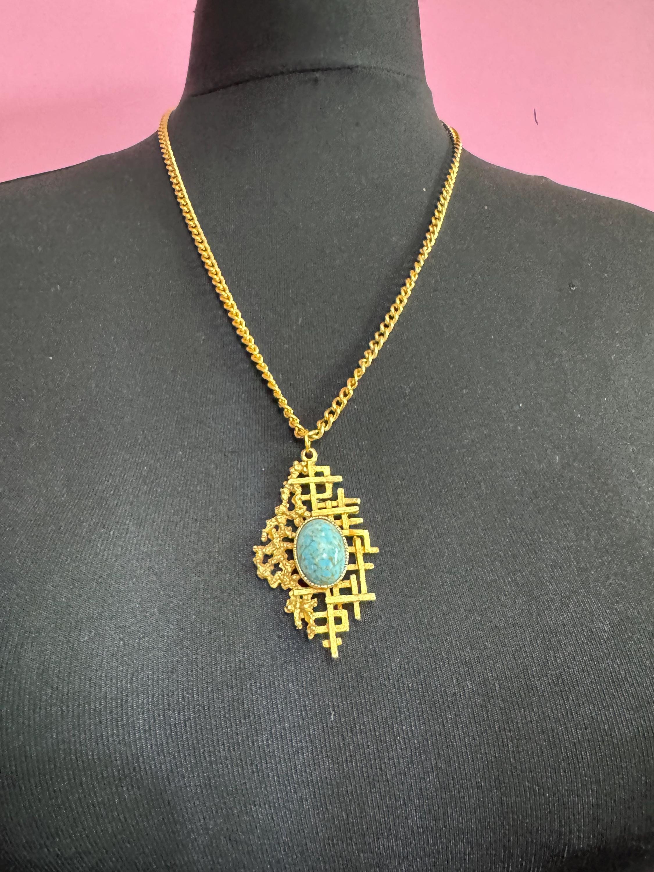 Vintage gold tone brutalist pendant with faux turquoise oval cabochon