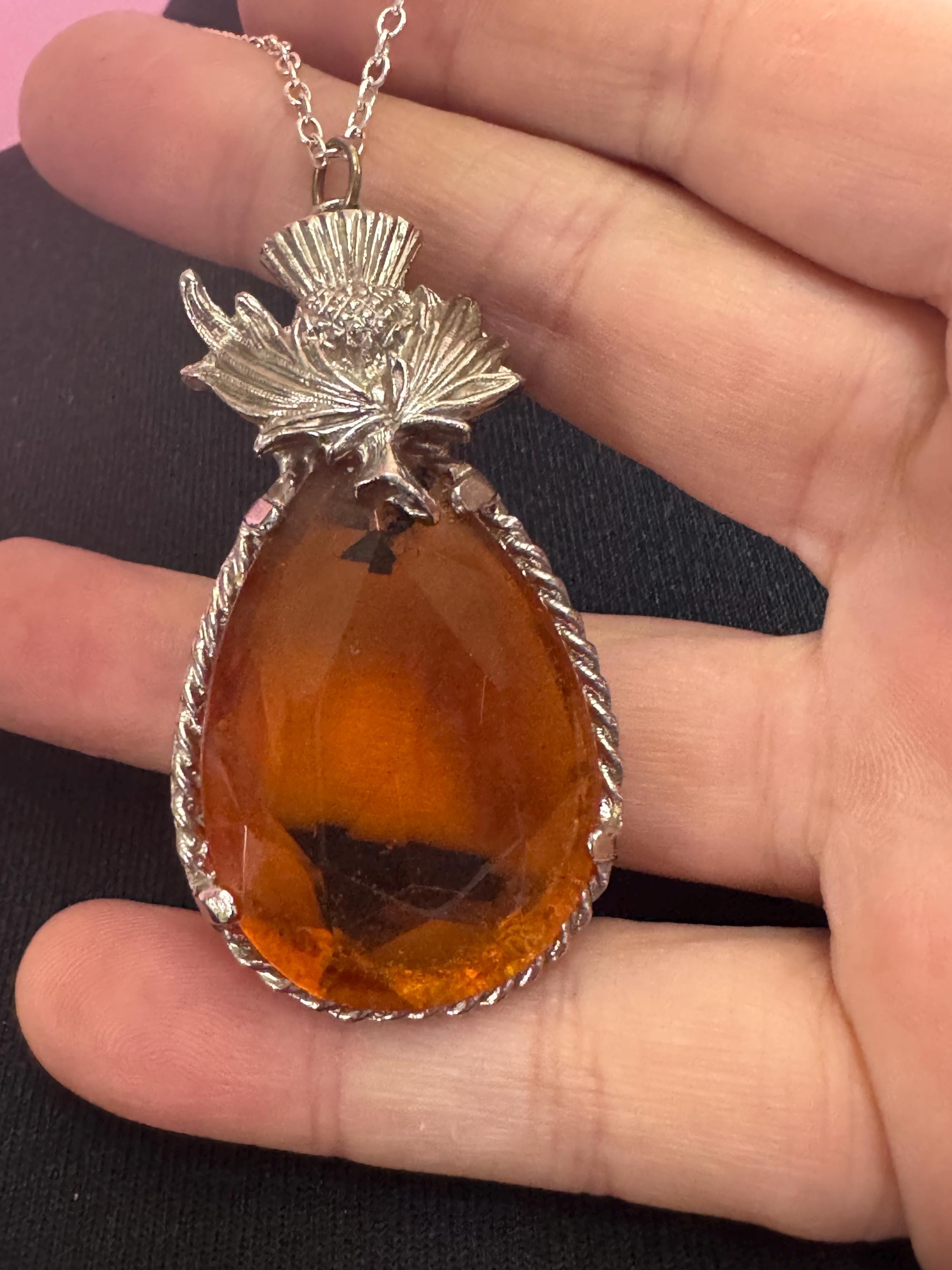 Scottish thistle orange faceted Glass teardrop pendant on 50cm later chain , silver tone