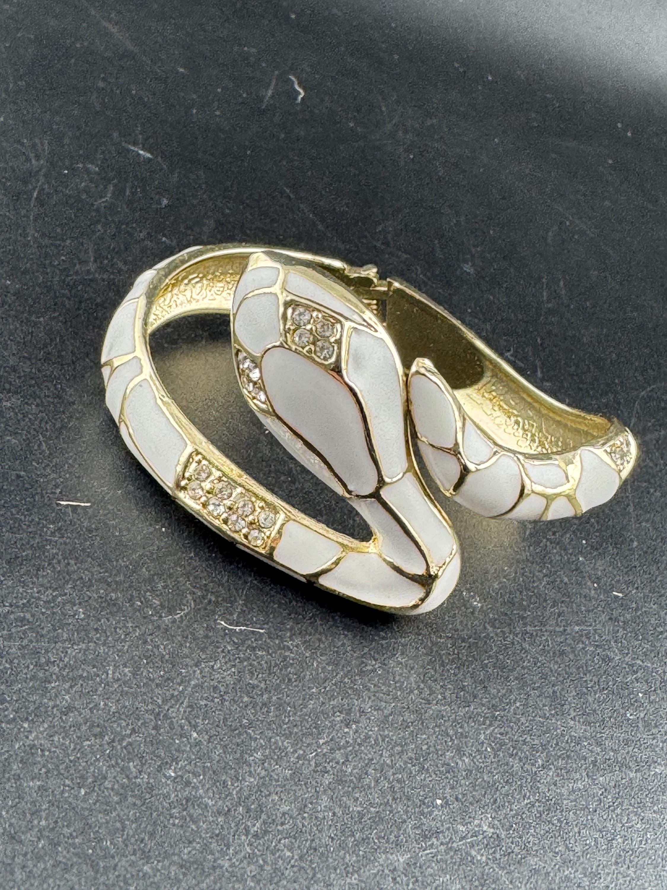 White enamel diamanté hinged snake bangle, clear rhinestone eyes gold tone