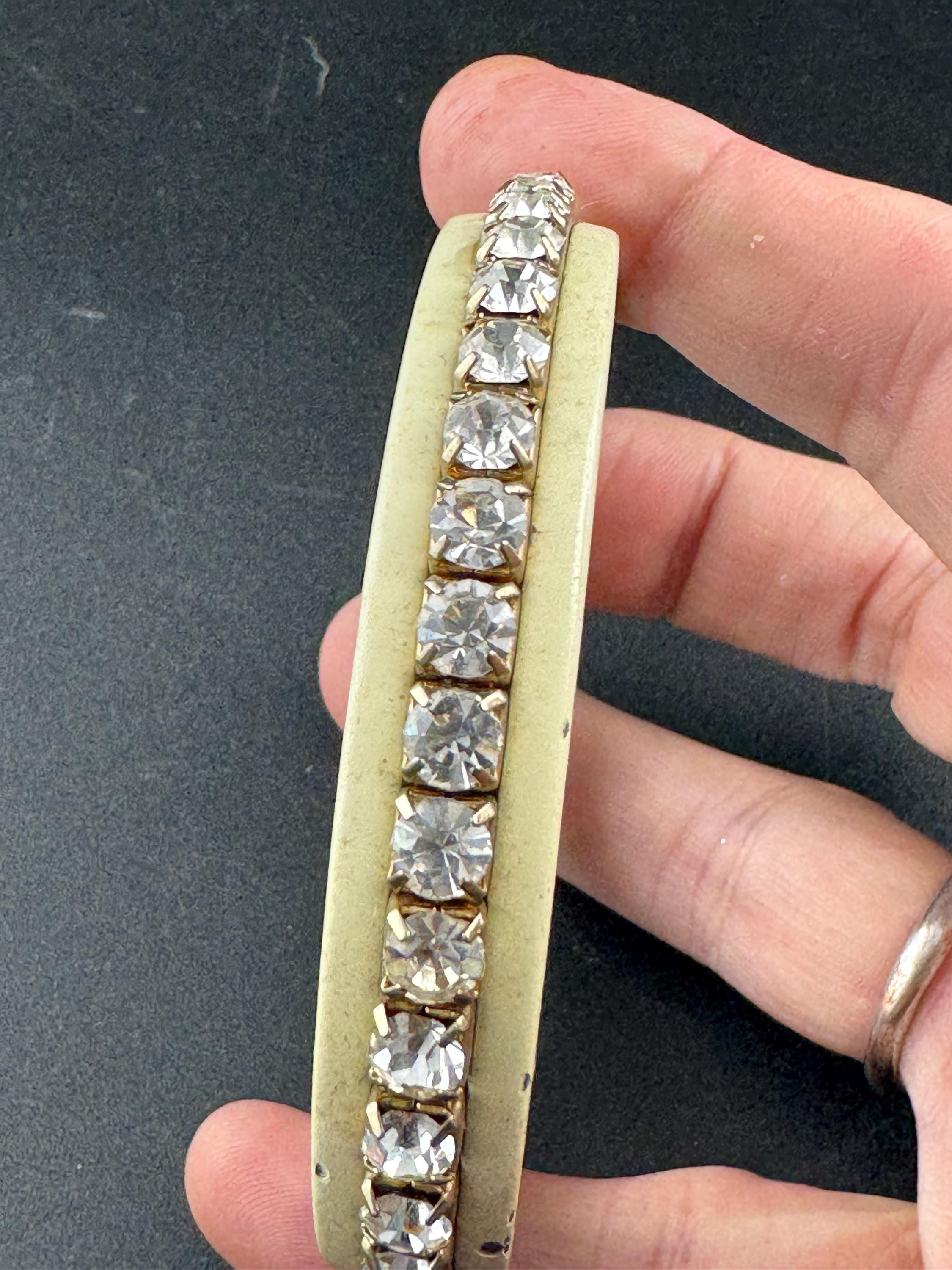 1960s cream enamel and clear diamanté fixed, slim bangle bracelet with wear