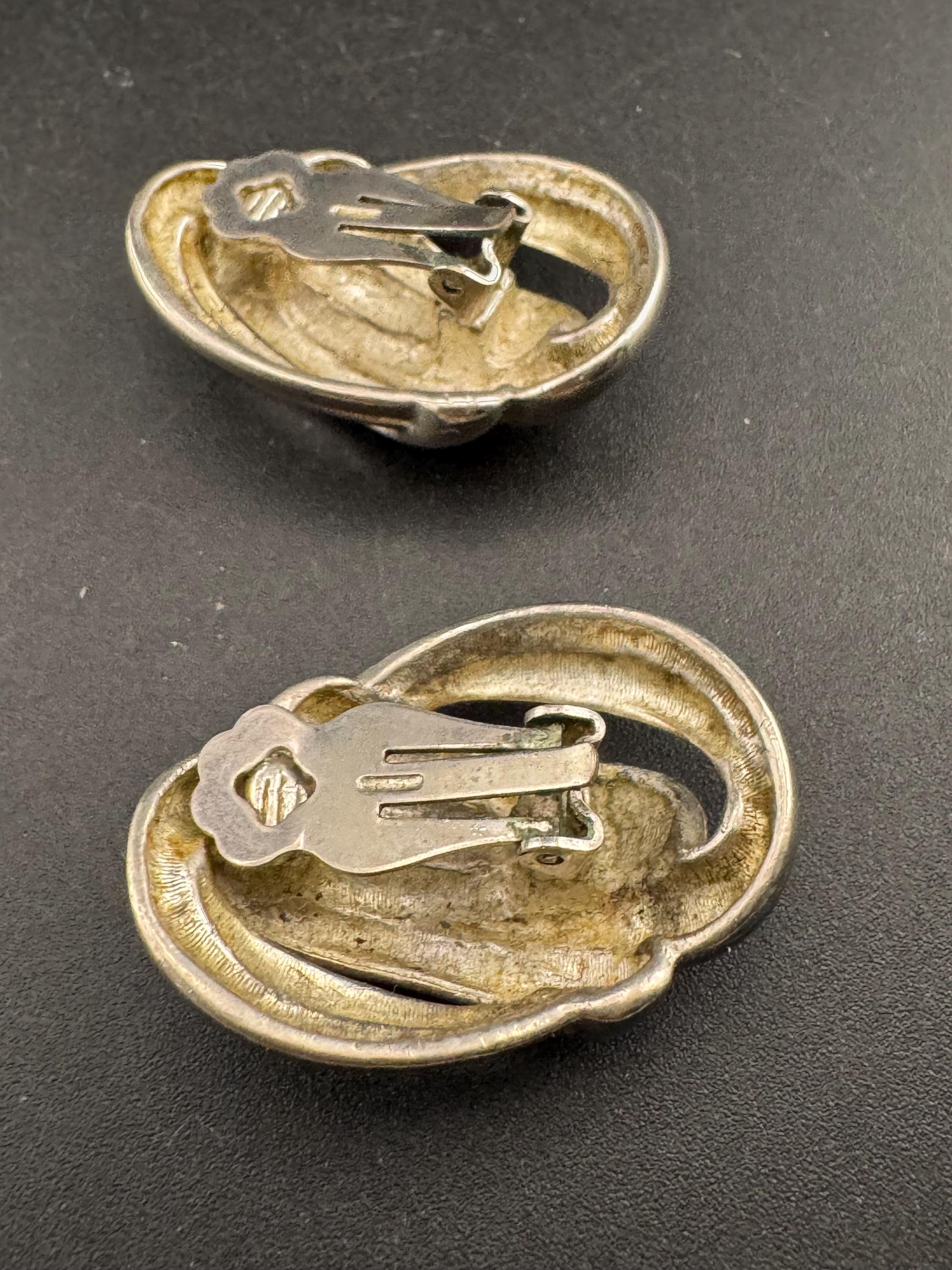 Vintage oversized silver metal swirl clip on earrings, 1980s