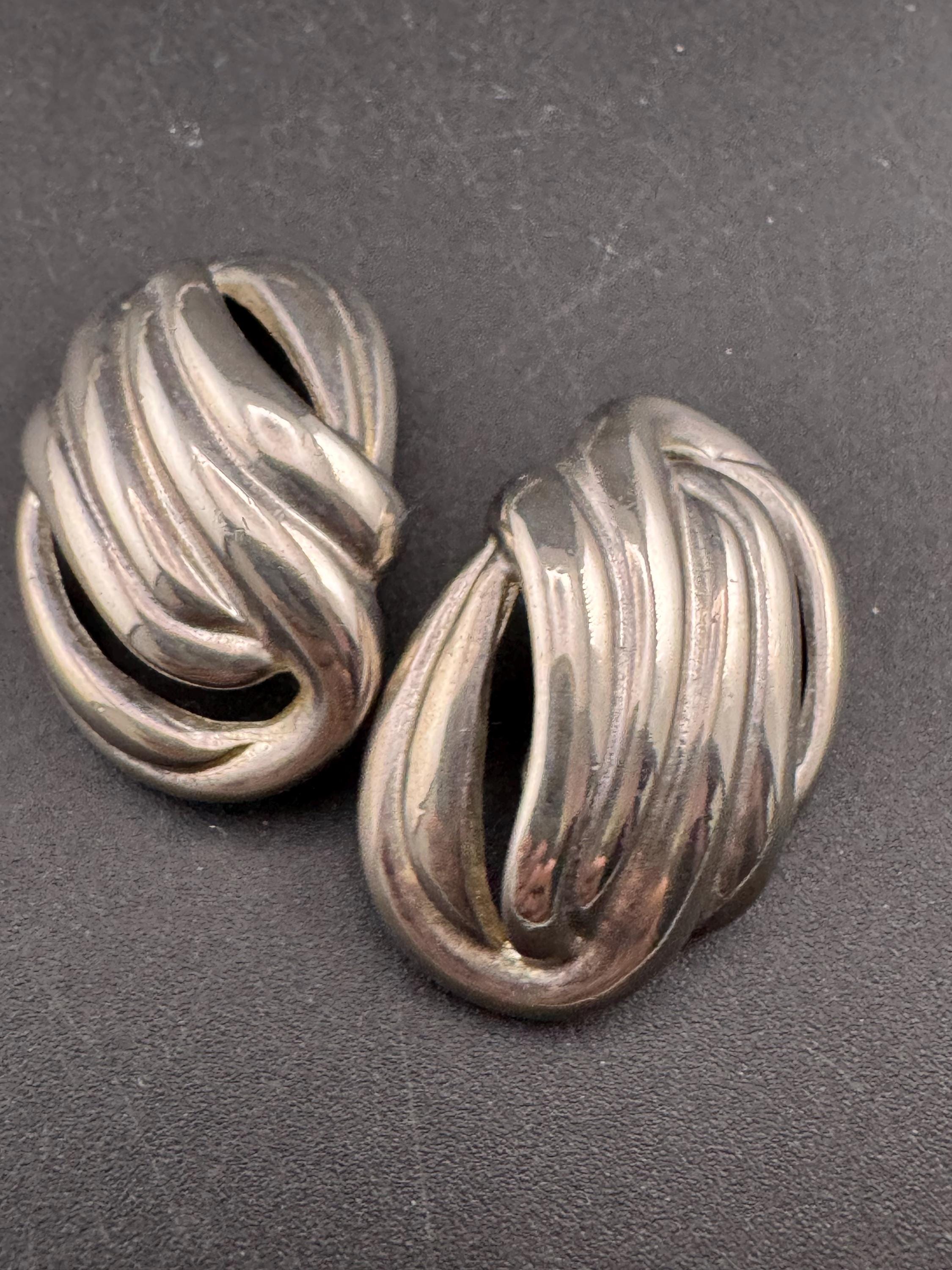 Vintage oversized silver metal swirl clip on earrings, 1980s