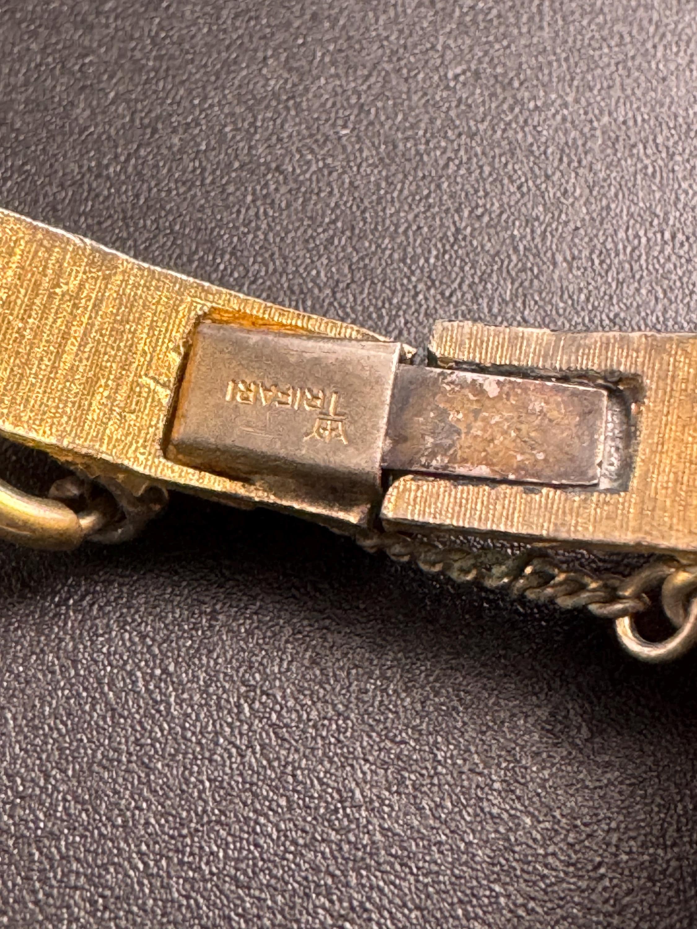 Crown Trifari gold-tone hinged bangle bracelet, textured snake or fish scale pattern