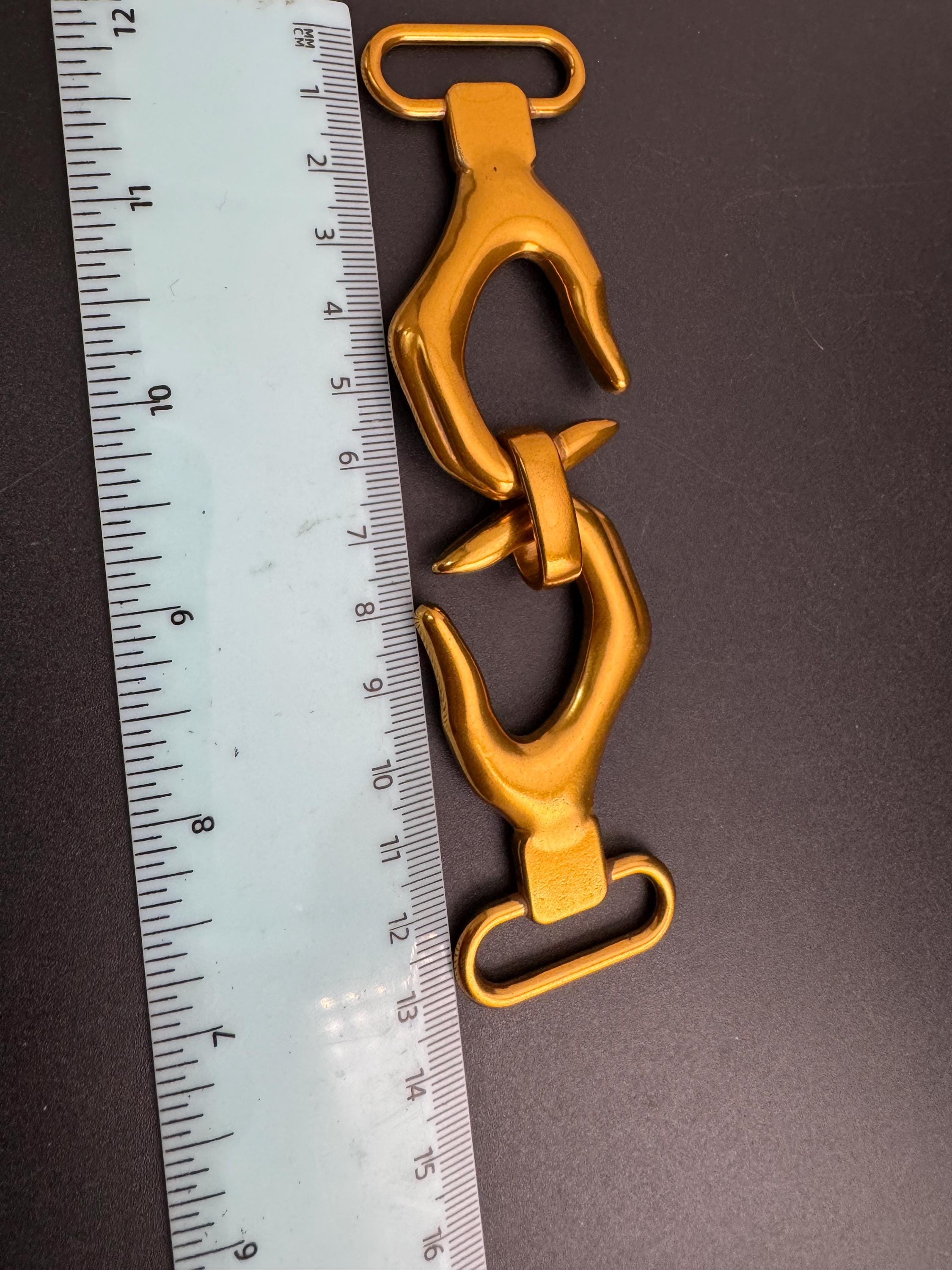 Novelty hand belt buckle, gold and silver tone 13cm