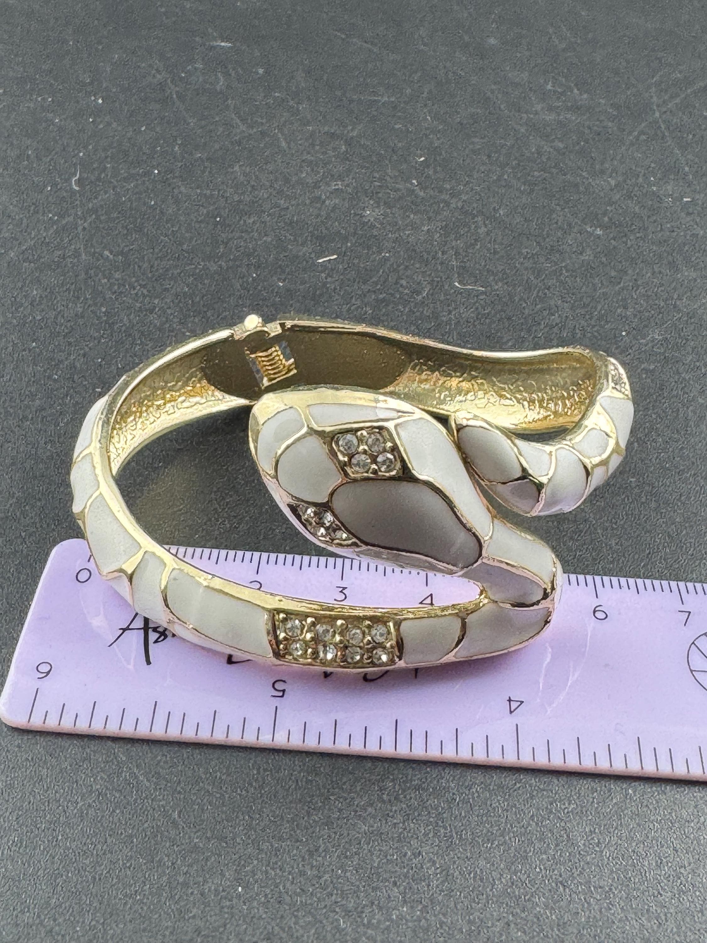 White enamel diamanté hinged snake bangle, clear rhinestone eyes gold tone
