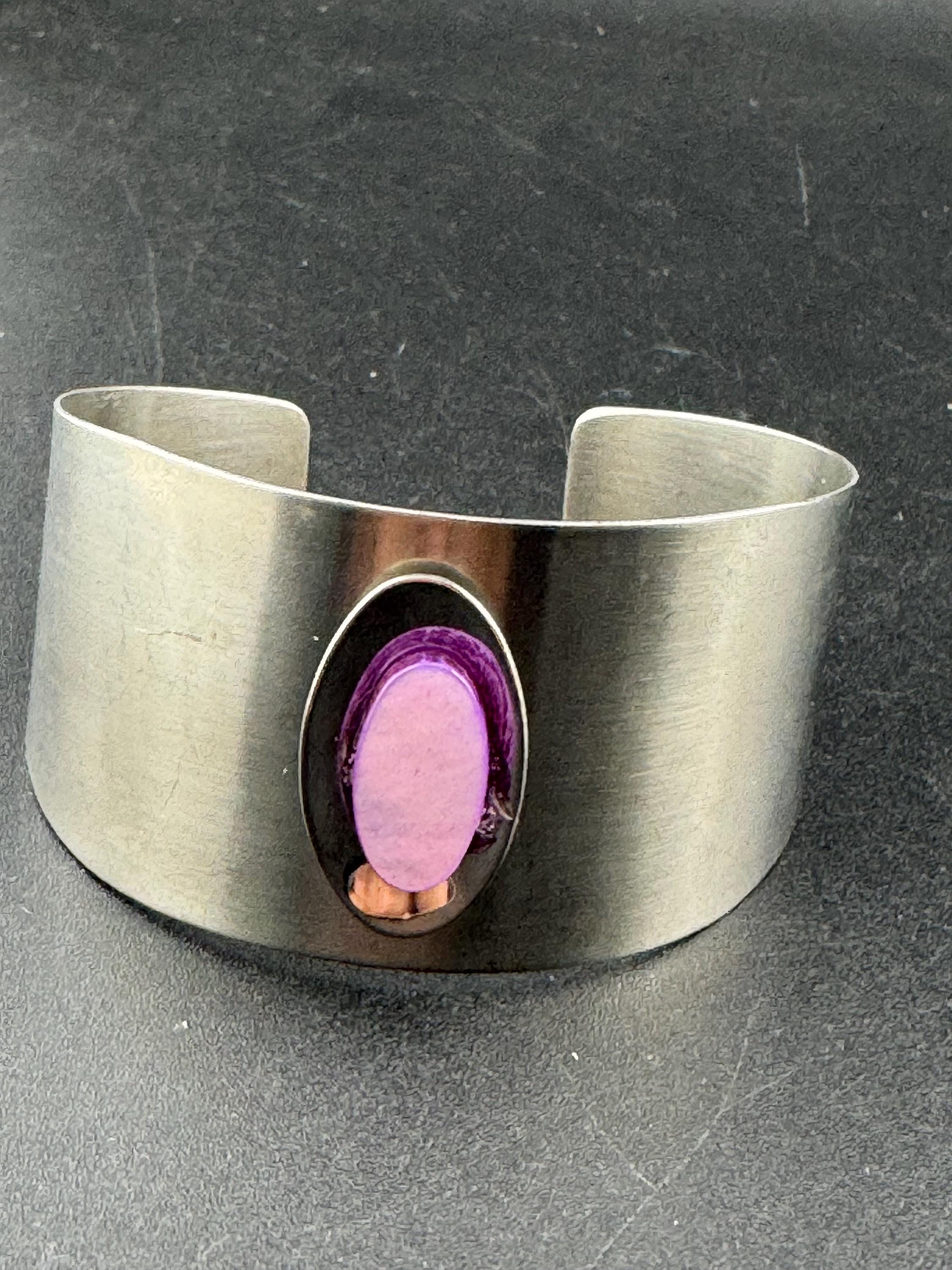 1970s stainless steel bangle, set with purple shell cabochon