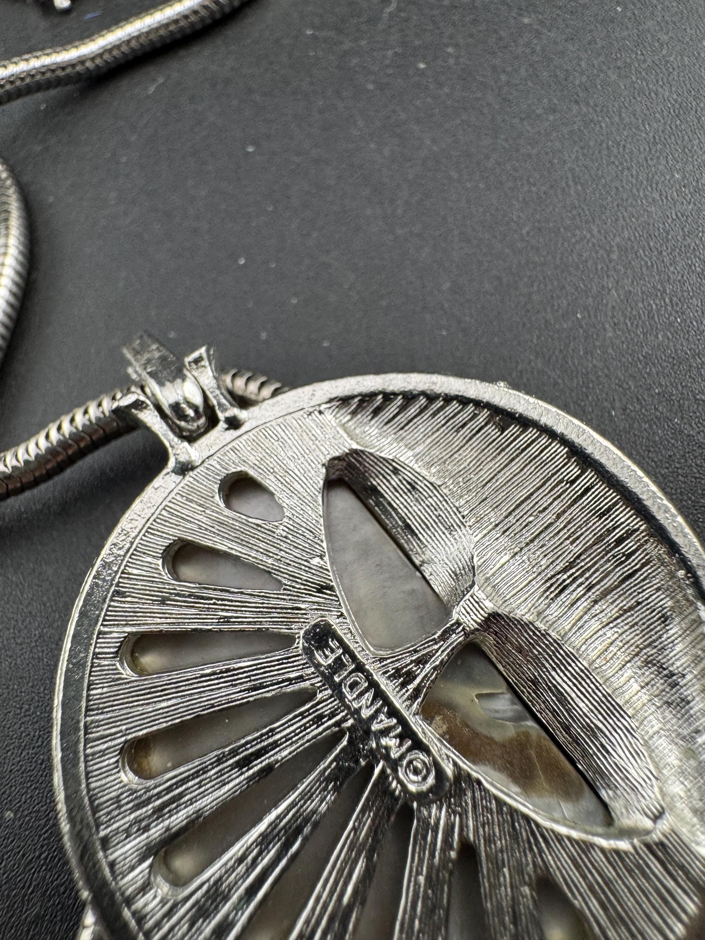 Signed MANDLE black enamel mother of pearl disc pendant on a snake chain necklace