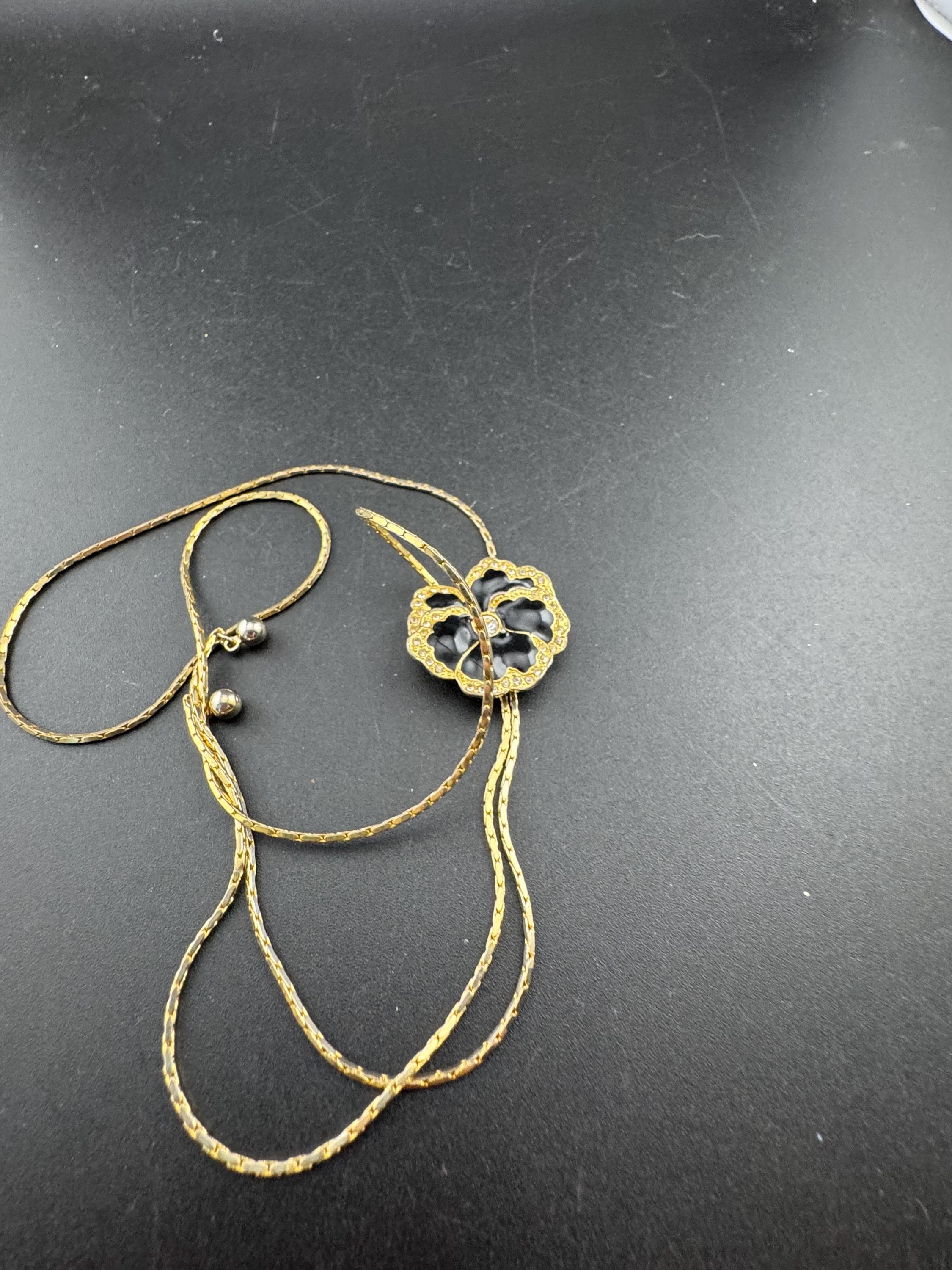 Vintage black enamel and crystal floral slider bolo necklace, with pat no , gold plated