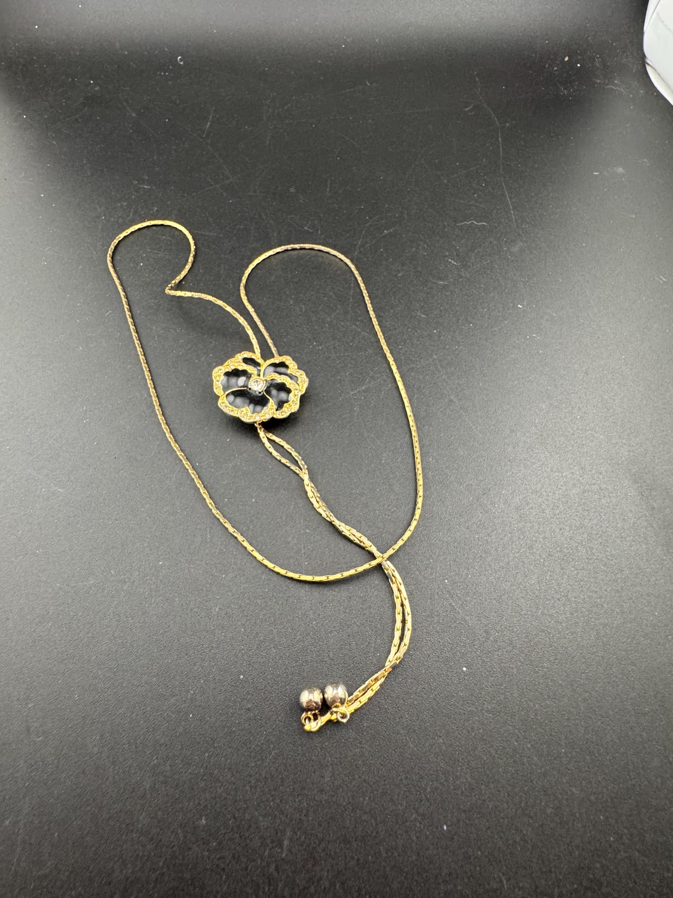 Vintage black enamel and crystal floral slider bolo necklace, with pat no , gold plated