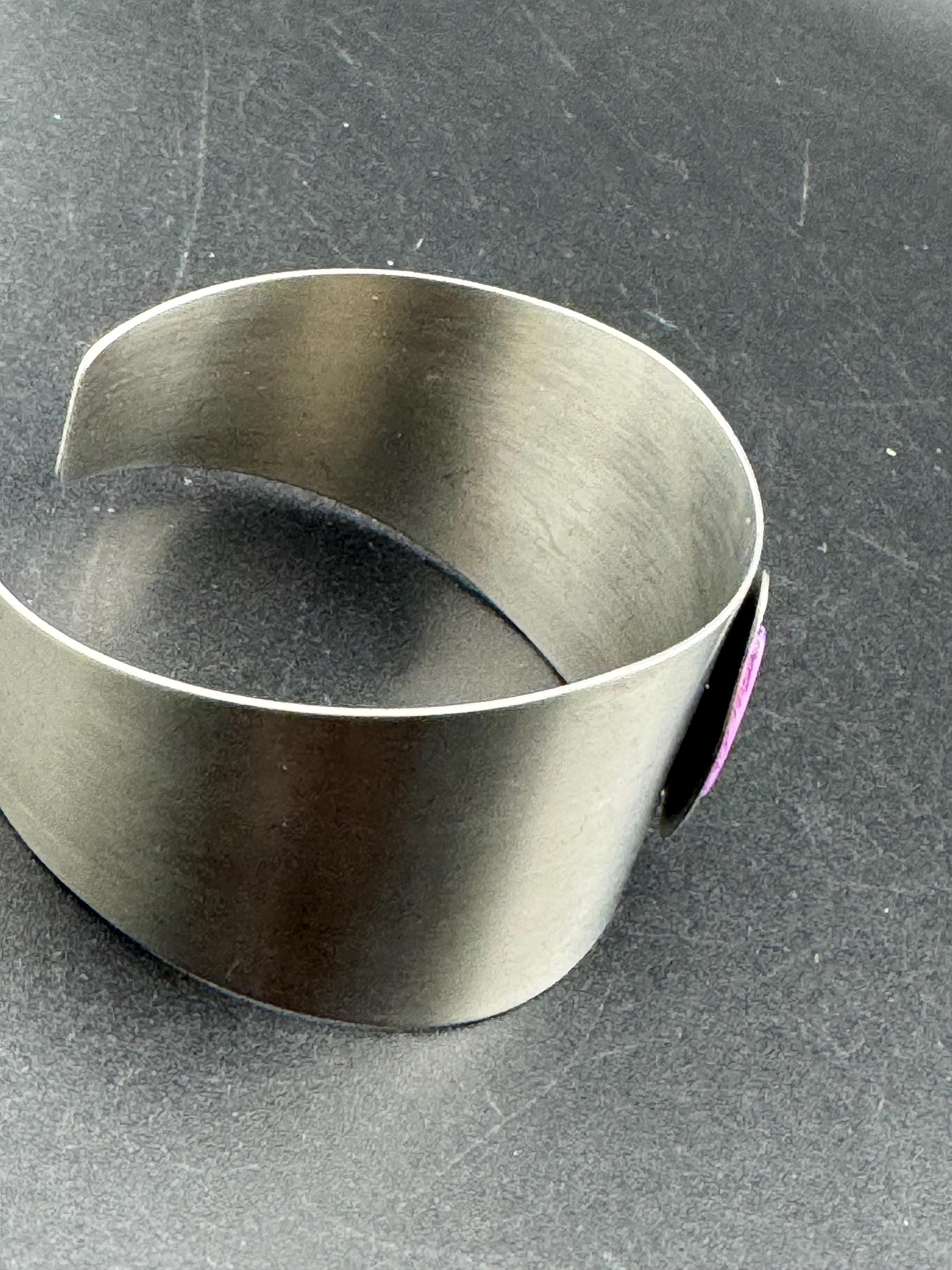 1970s stainless steel bangle, set with purple shell cabochon