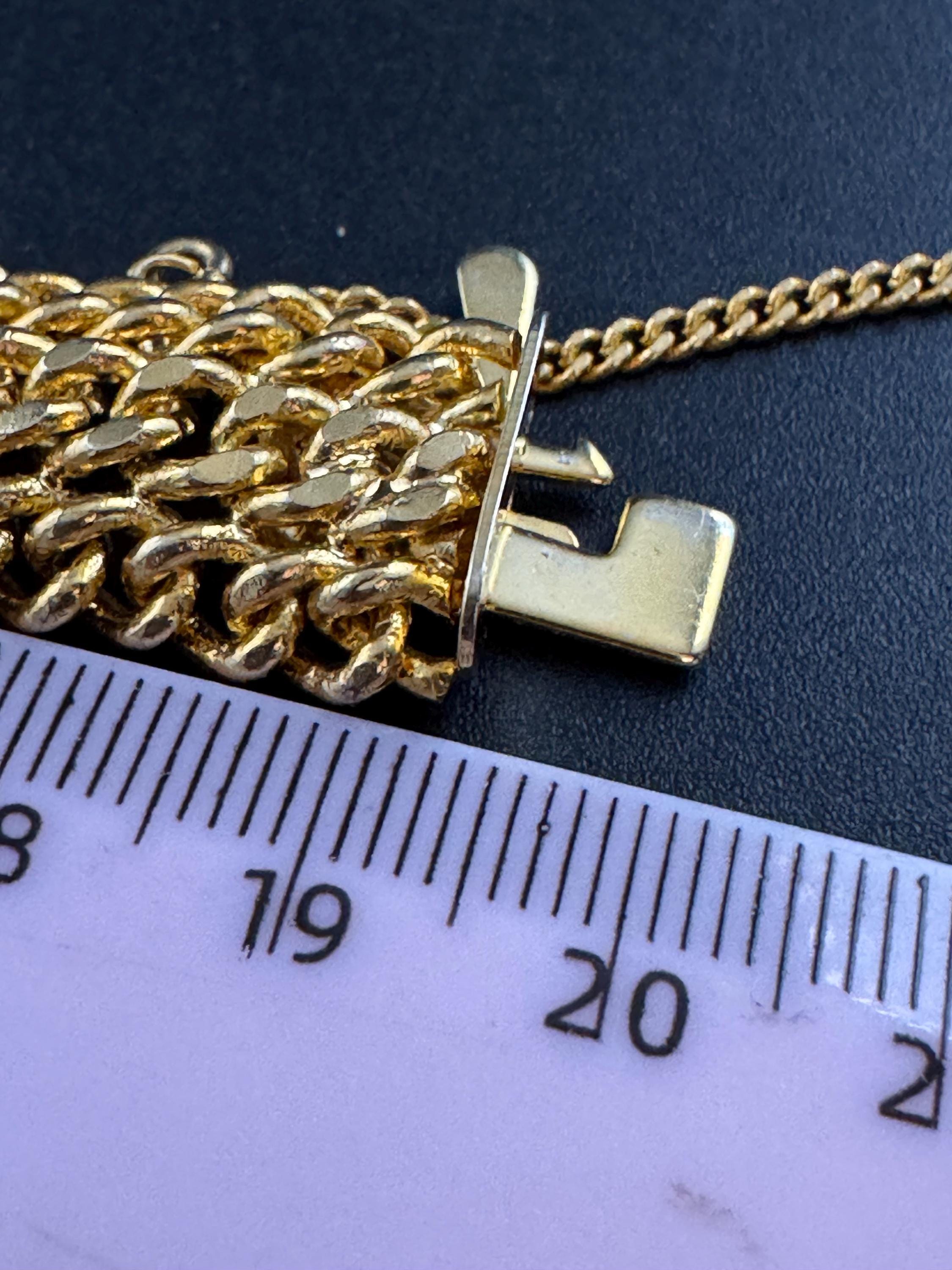 bright gold tone wide woven curb chain bracelet , with safety chain