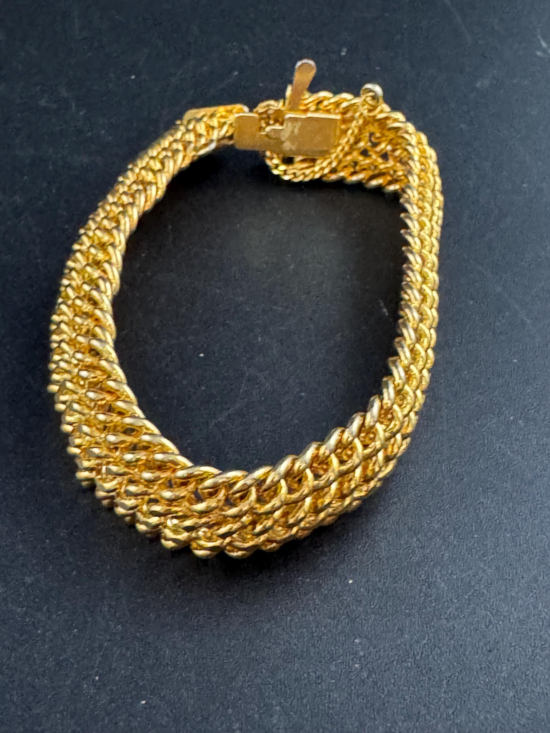 bright gold tone wide woven curb chain bracelet , with safety chain