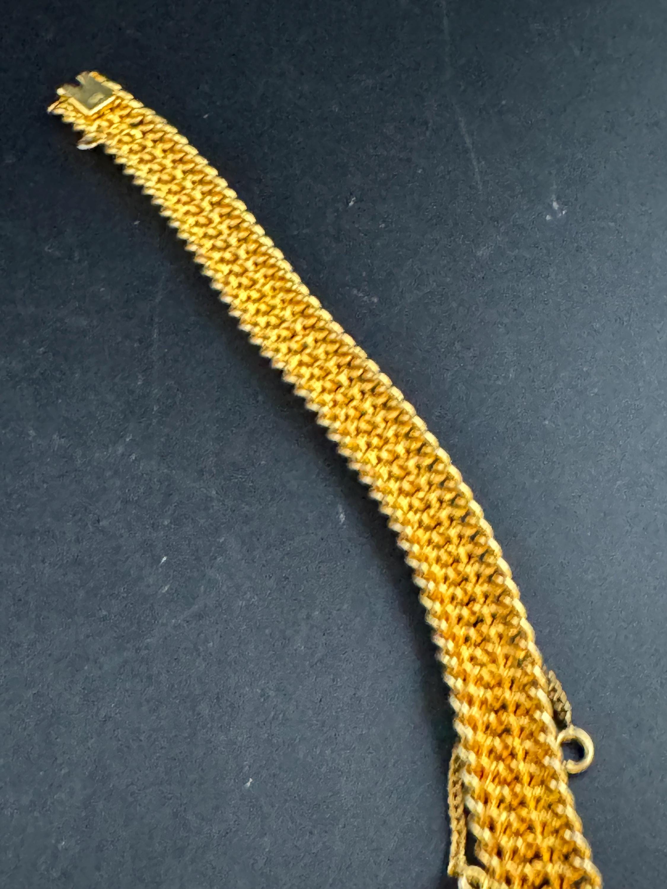 bright gold tone wide woven curb chain bracelet , with safety chain