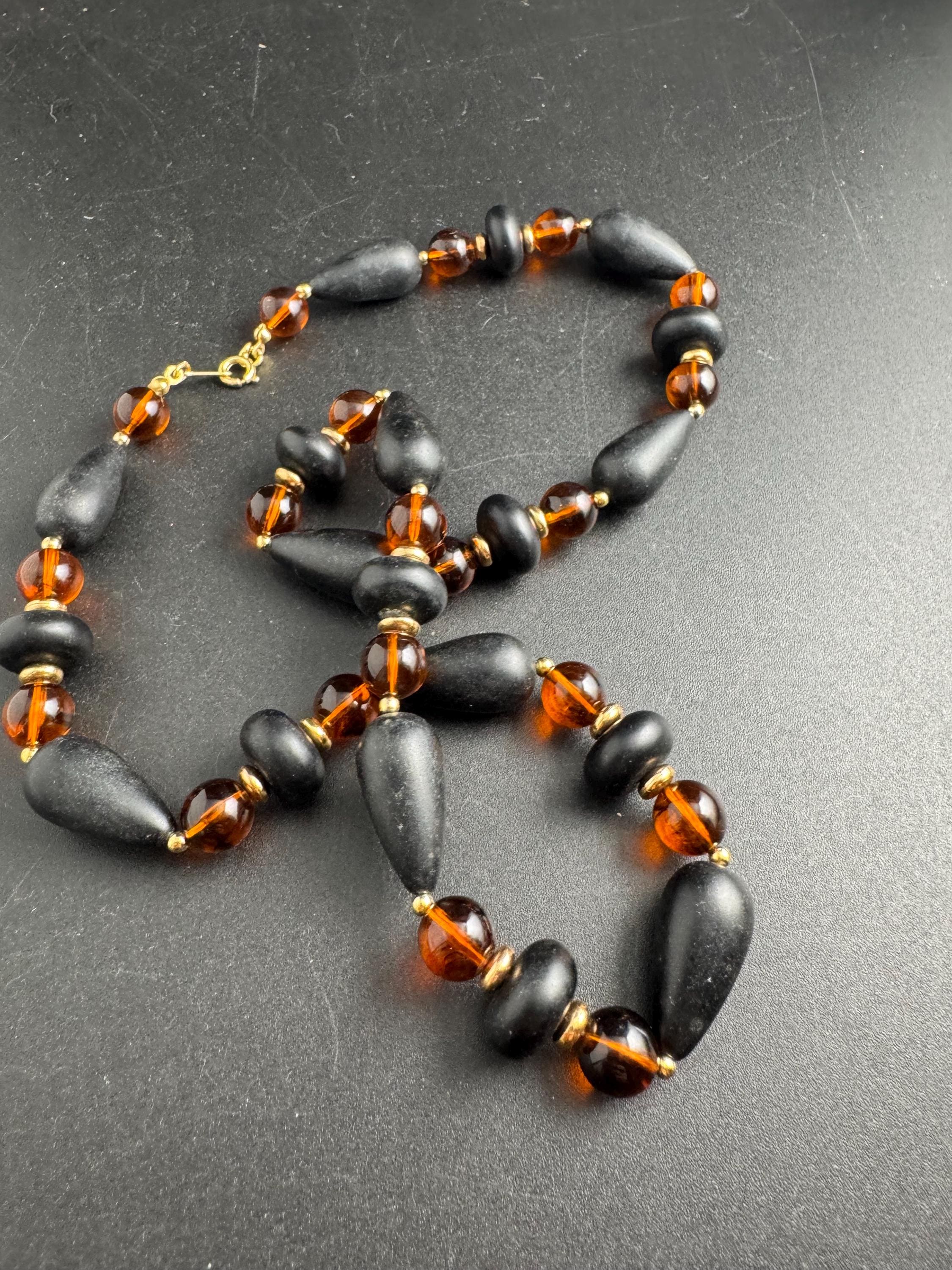 Long Faux Amber orange black beaded necklace, plastic beads