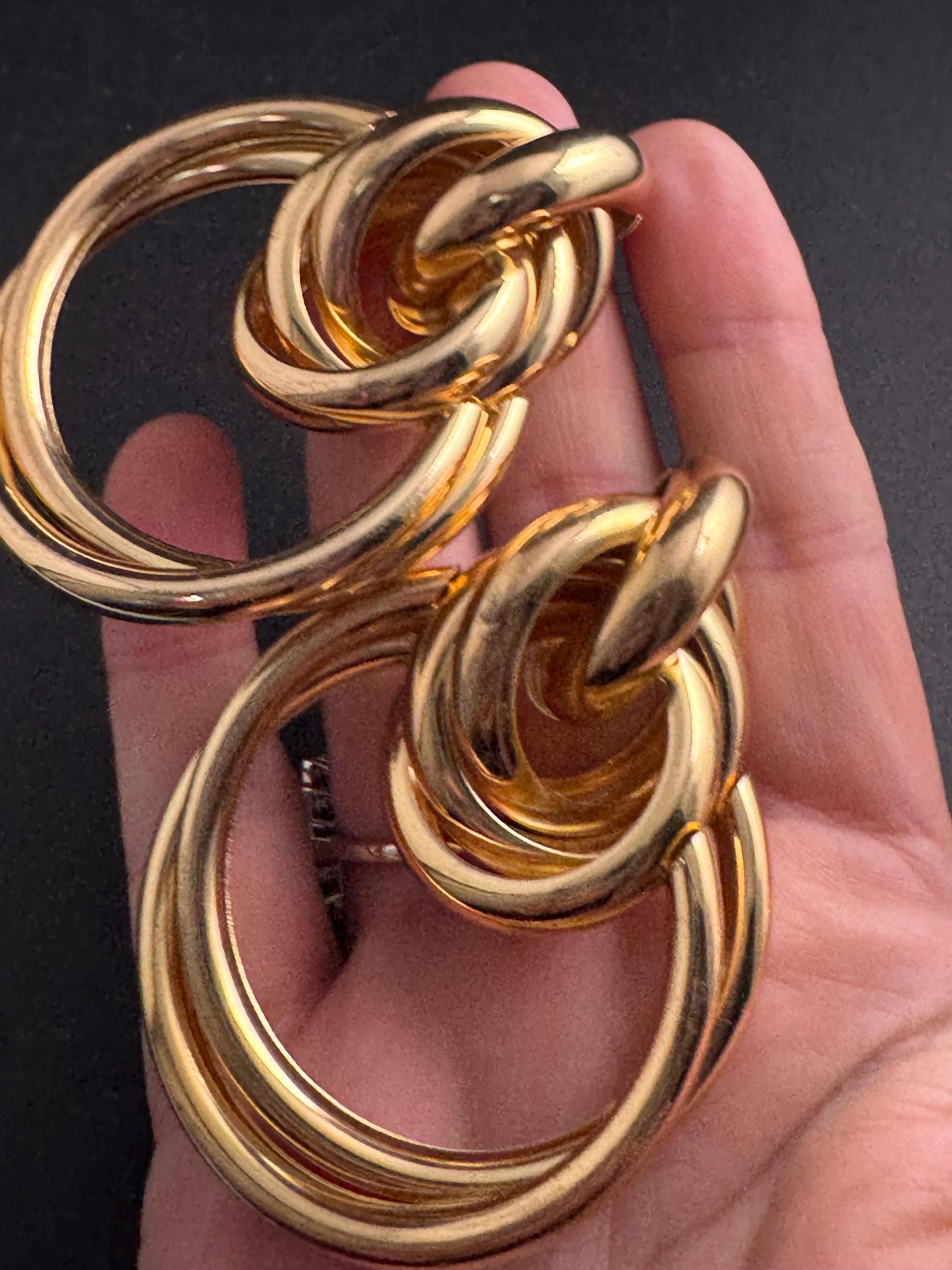 Oversized gold tube knot earrings for pierced ears, 1980s