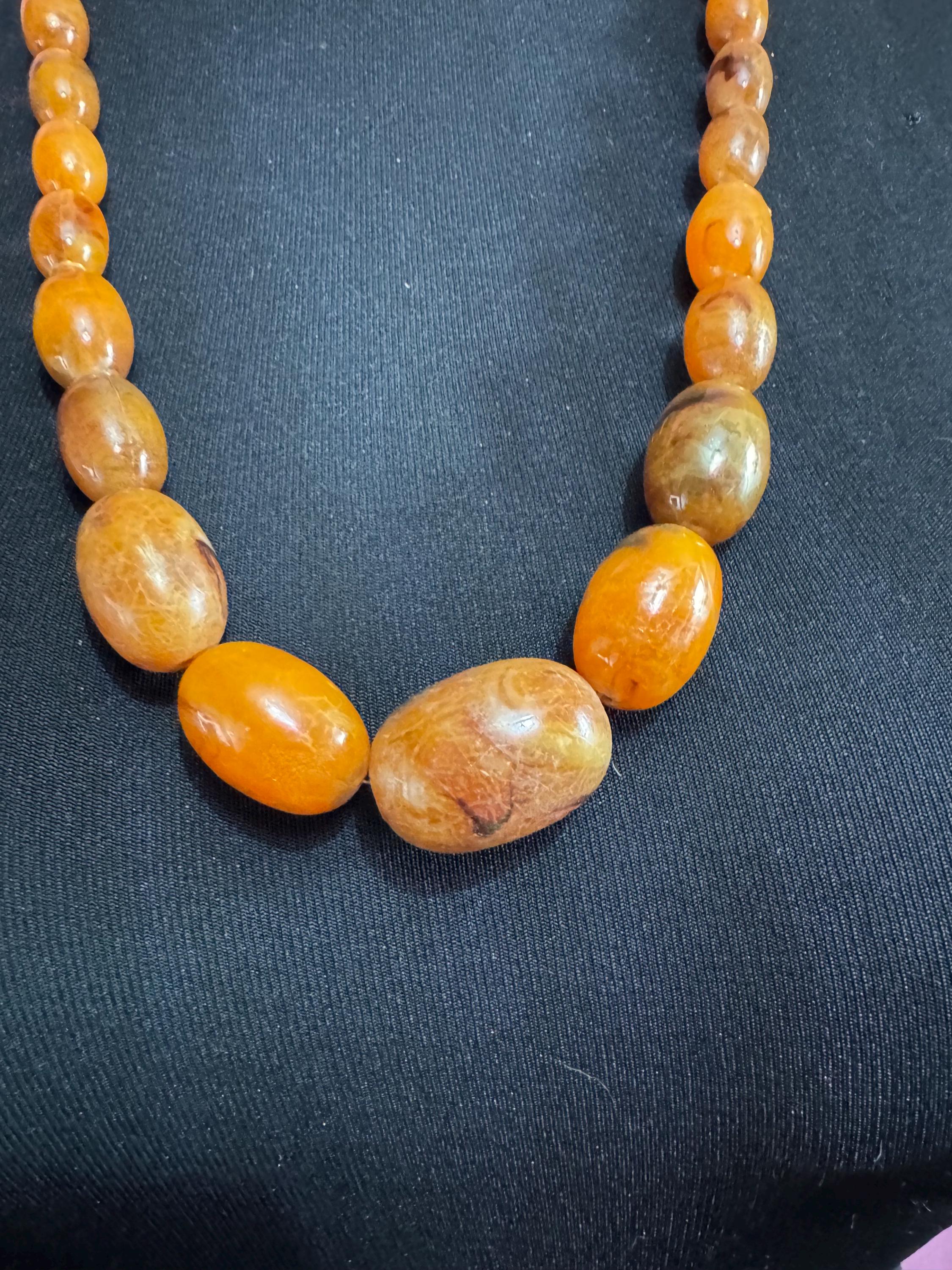 Long Faux Amber orange brown beaded necklace, oval plastic beads