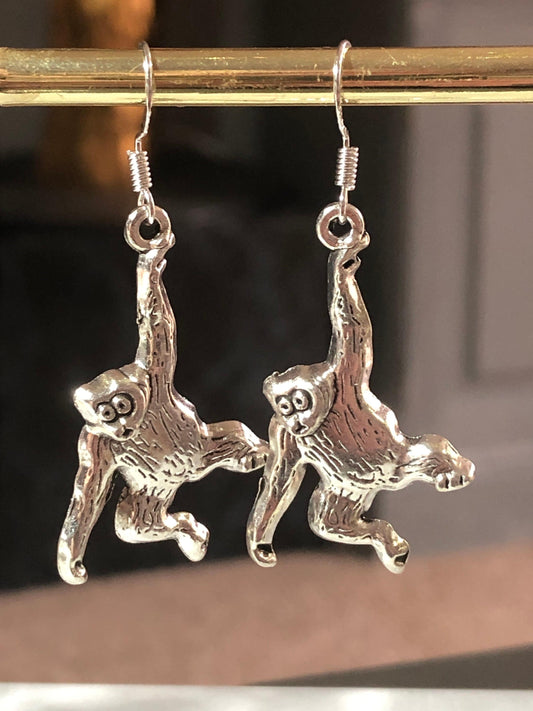 hanging monkey silver tone drop earrings
