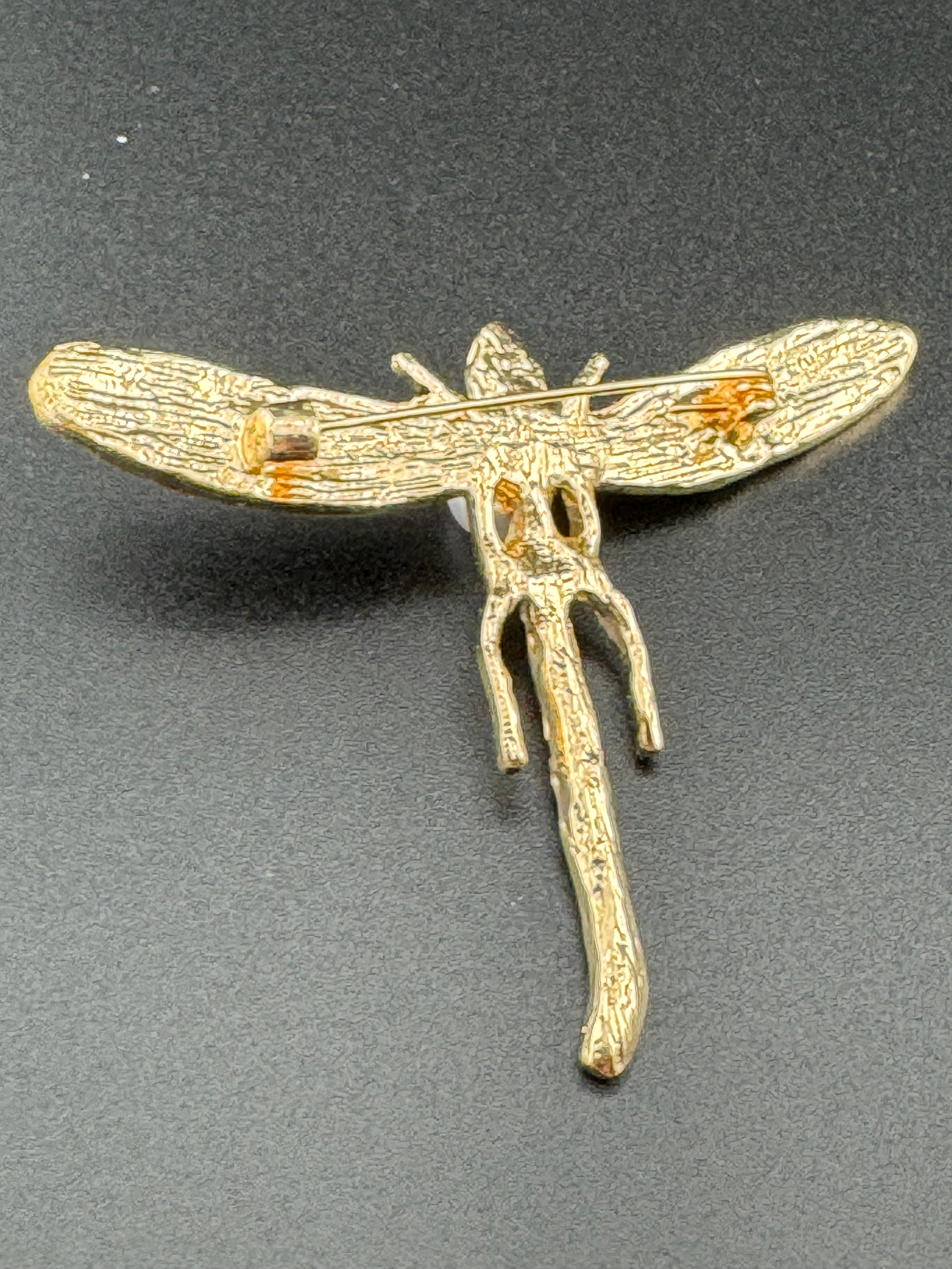 Gold dragonfly brooch set with a peal and green rhinestones