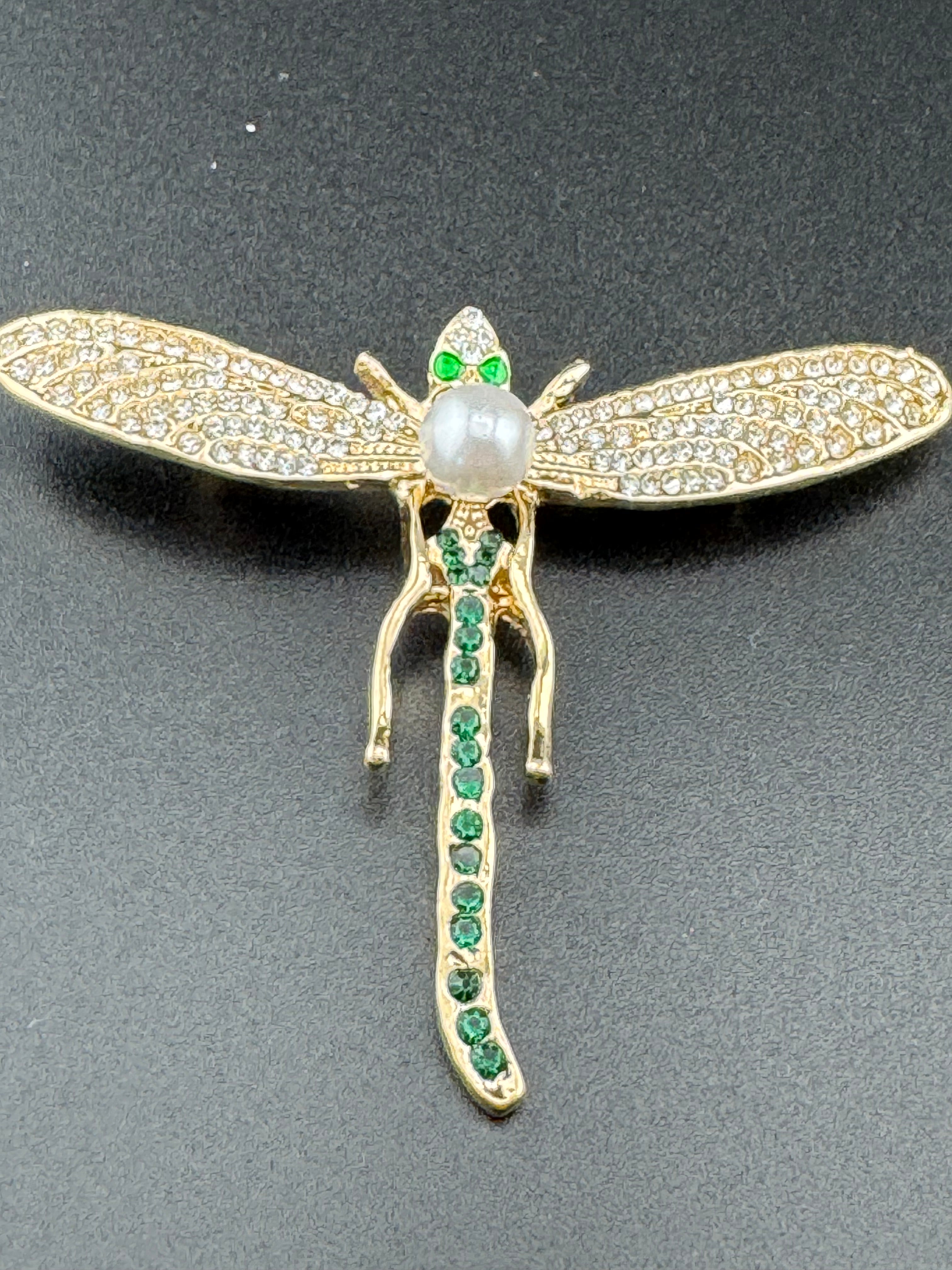 Gold dragonfly brooch set with a peal and green rhinestones
