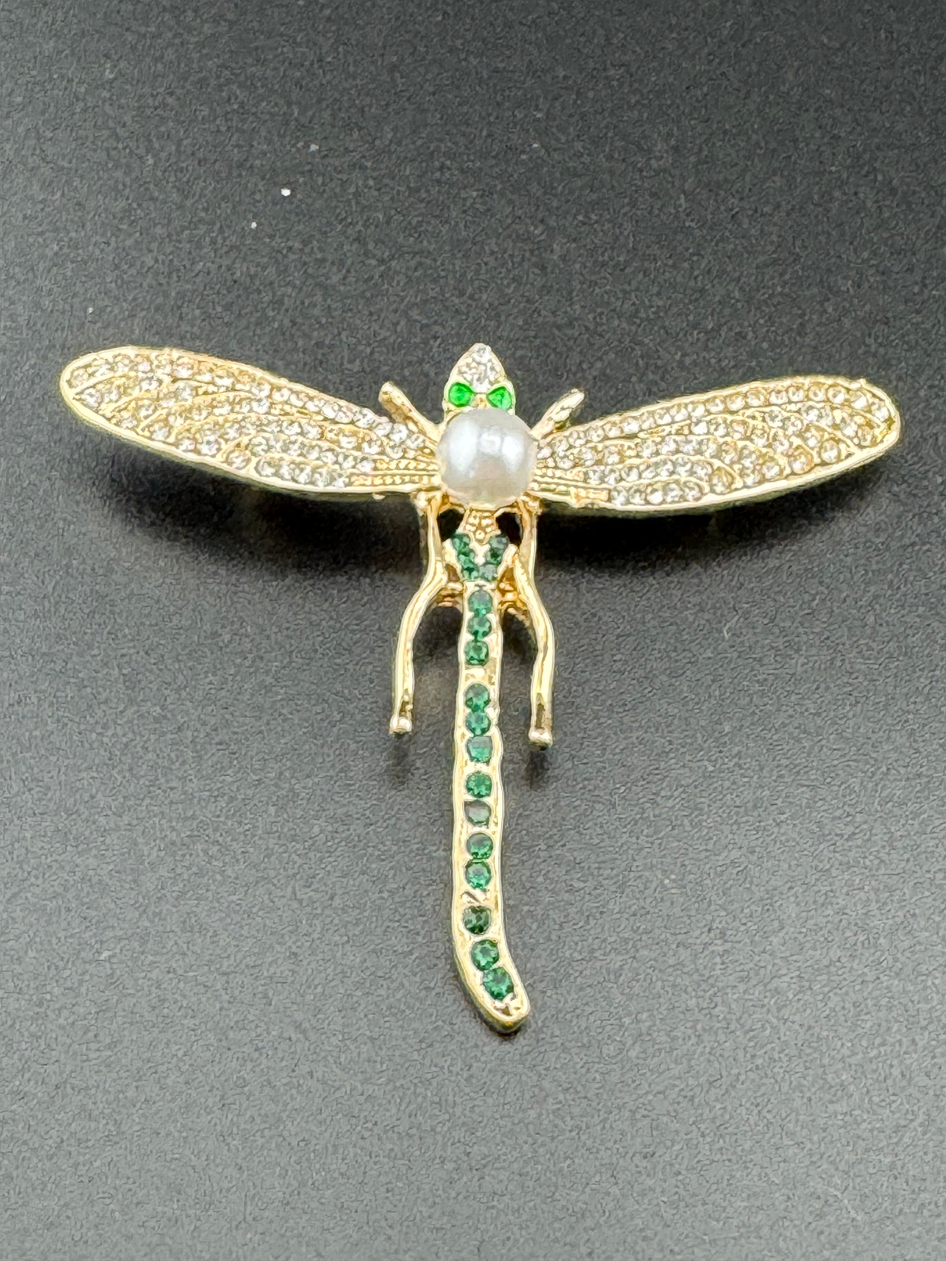 Gold dragonfly brooch set with a peal and green rhinestones