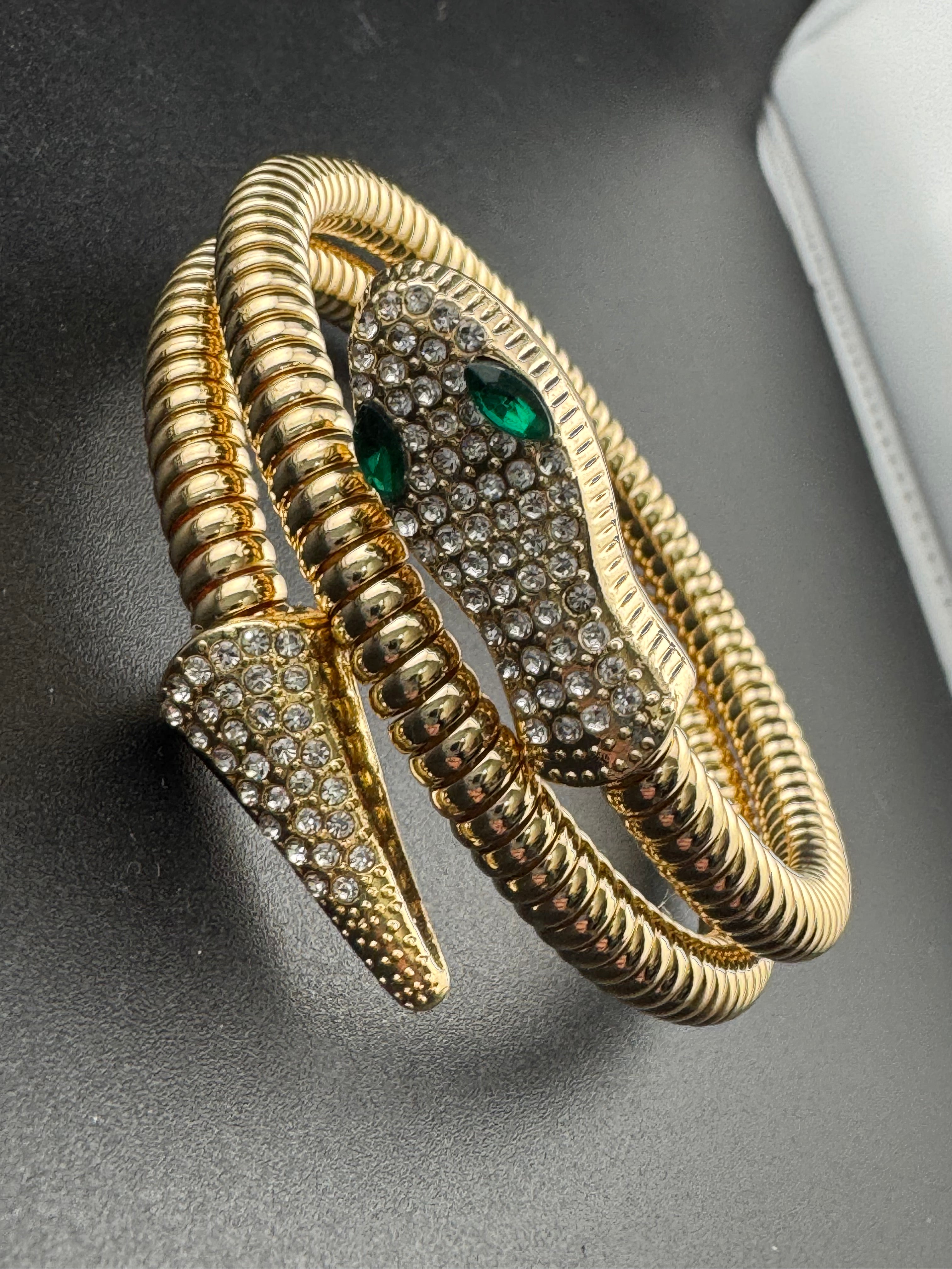 Gold crystal bendy wrap around omega snake bracelet with emerald eyes