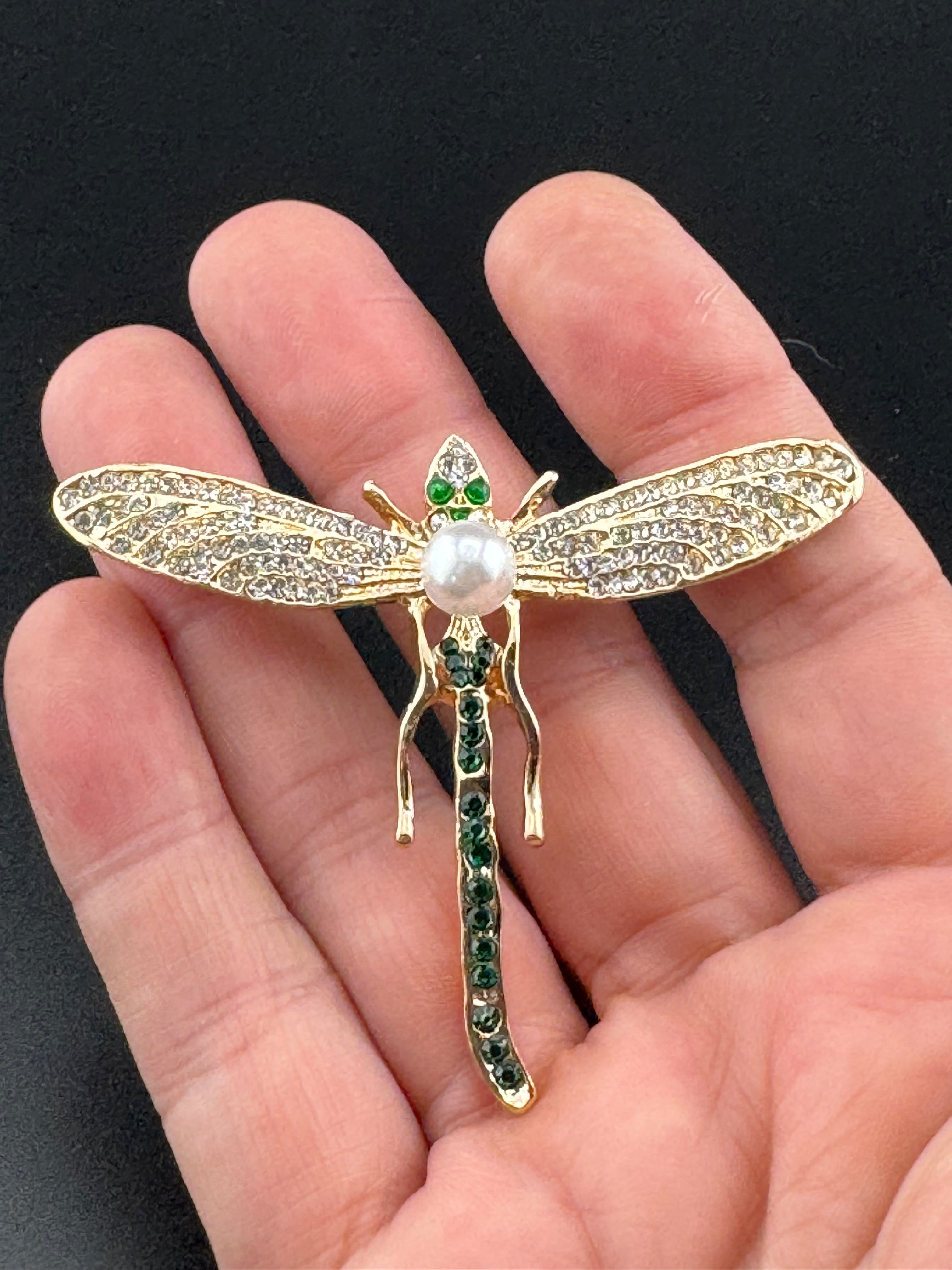 Gold dragonfly brooch set with a peal and green rhinestones