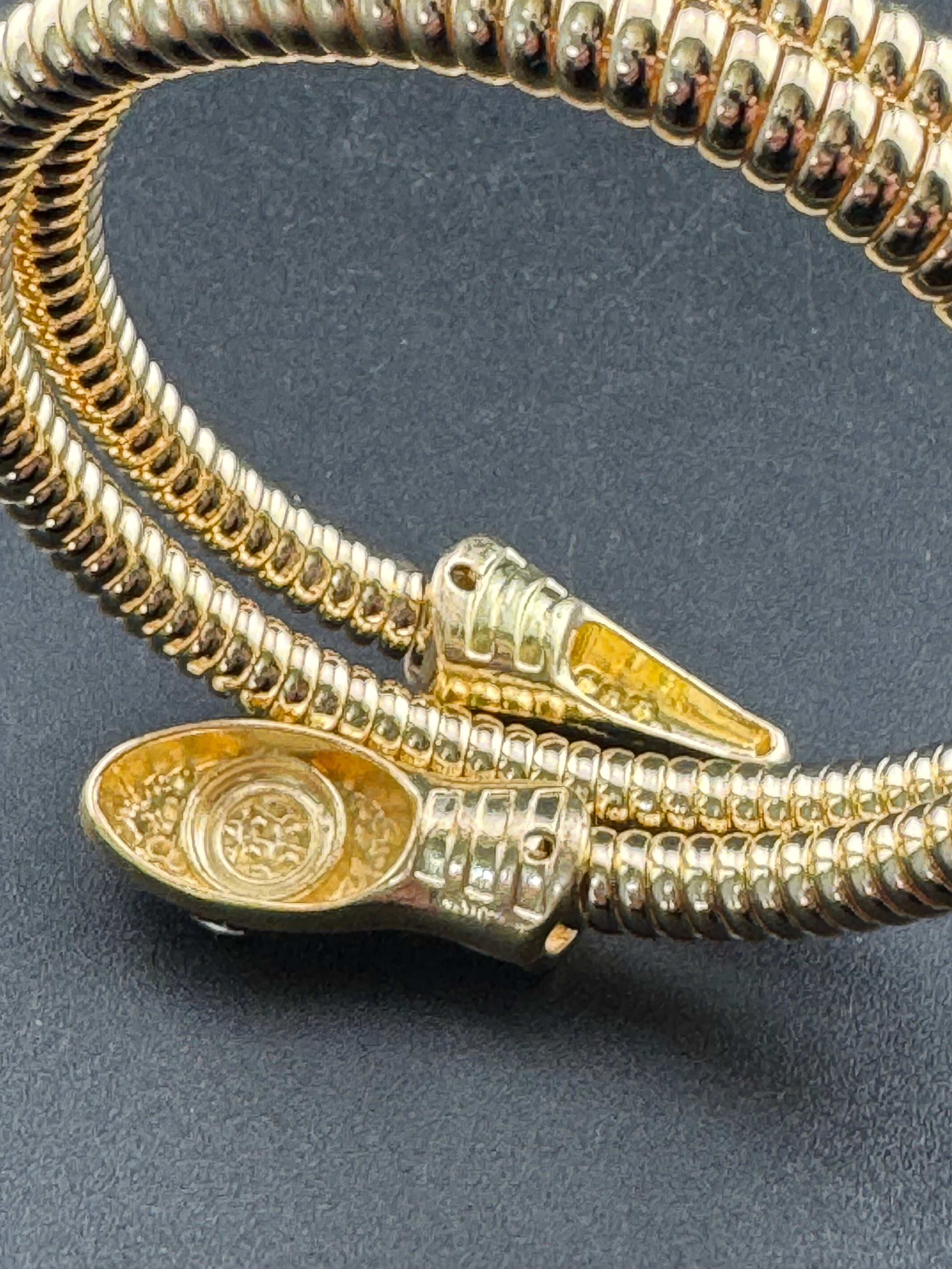 Gold crystal bendy wrap around omega snake bracelet with emerald eyes