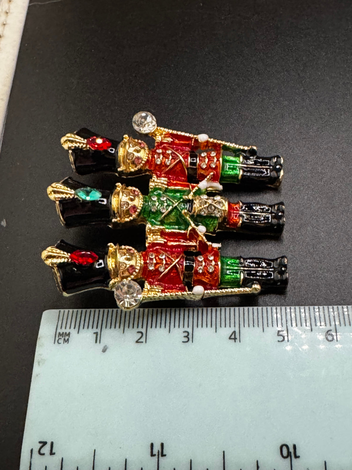 Novelty diamanté nutcracker soldier enamel brooch, red and gold enamel, festive jewellery