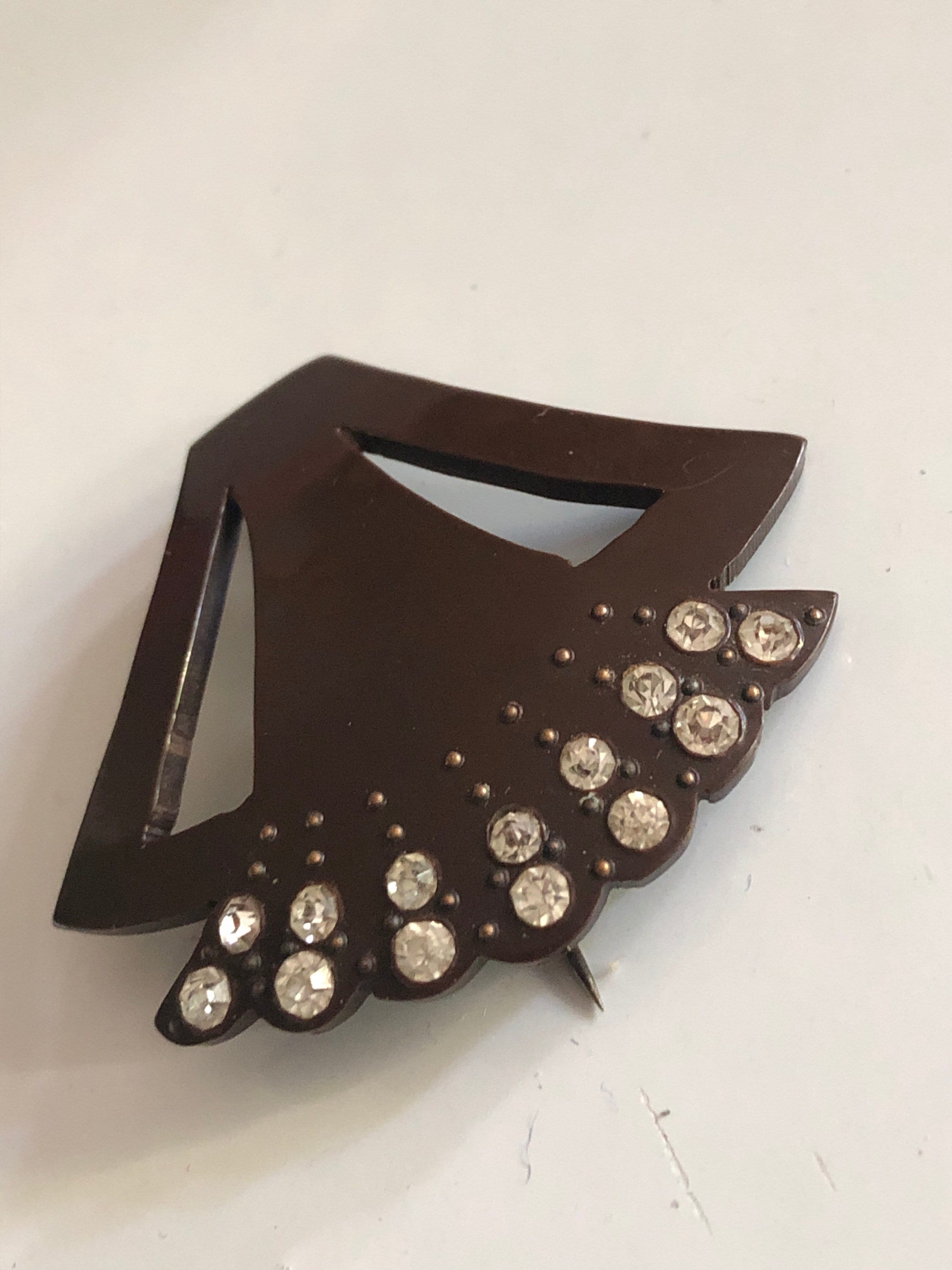 Brown early plastic hat flash pin with rhinestones paste brown pique work bakelite art deco