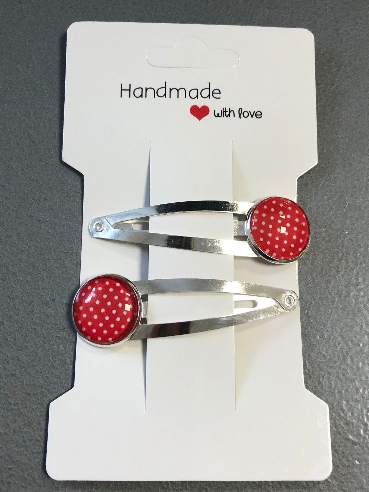 pair of red & white polka dot hair clips silver tone snap lock closure