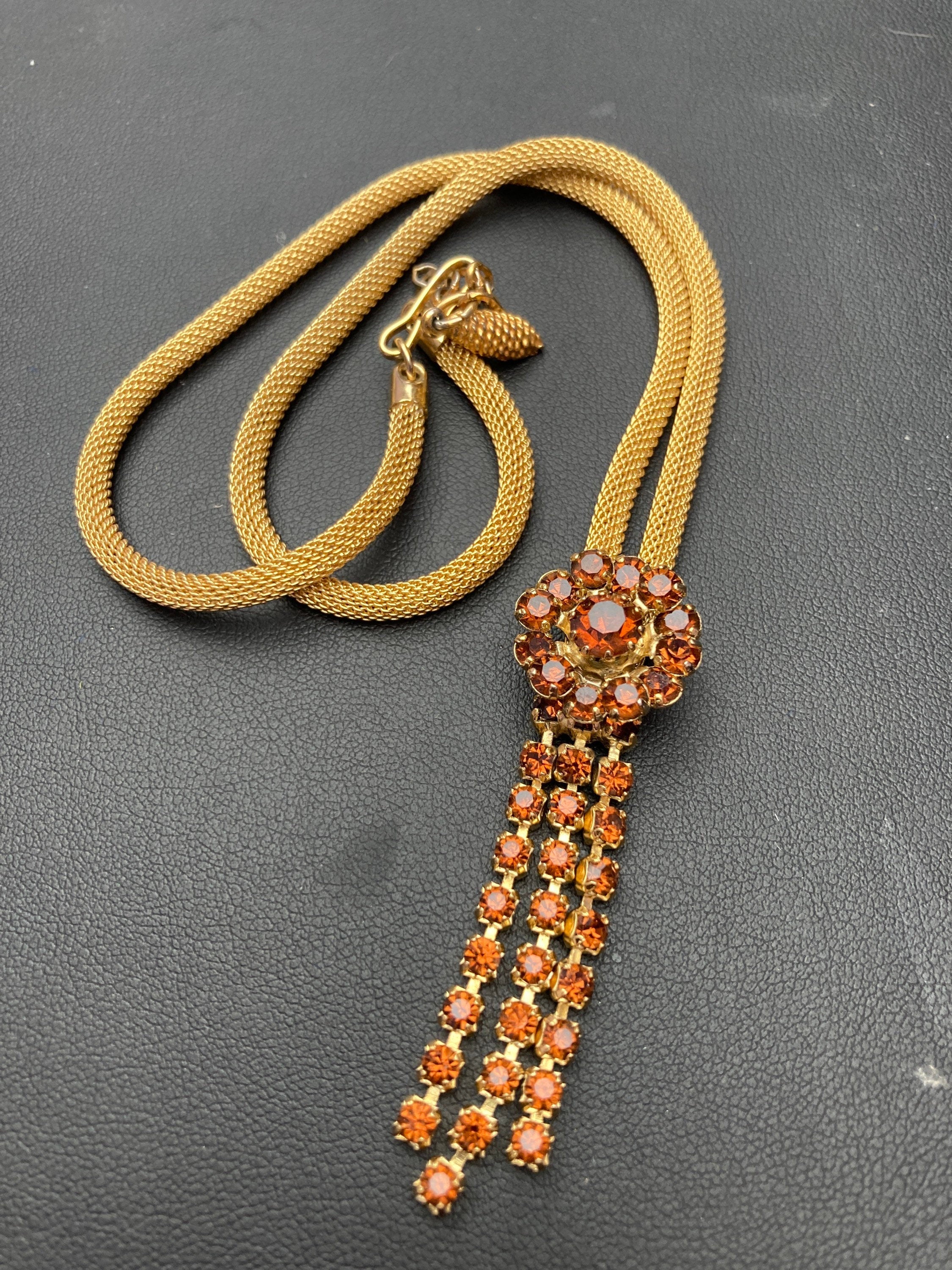 Vintage gold tone mesh lariat drop necklace with brown cognac glass paste stones