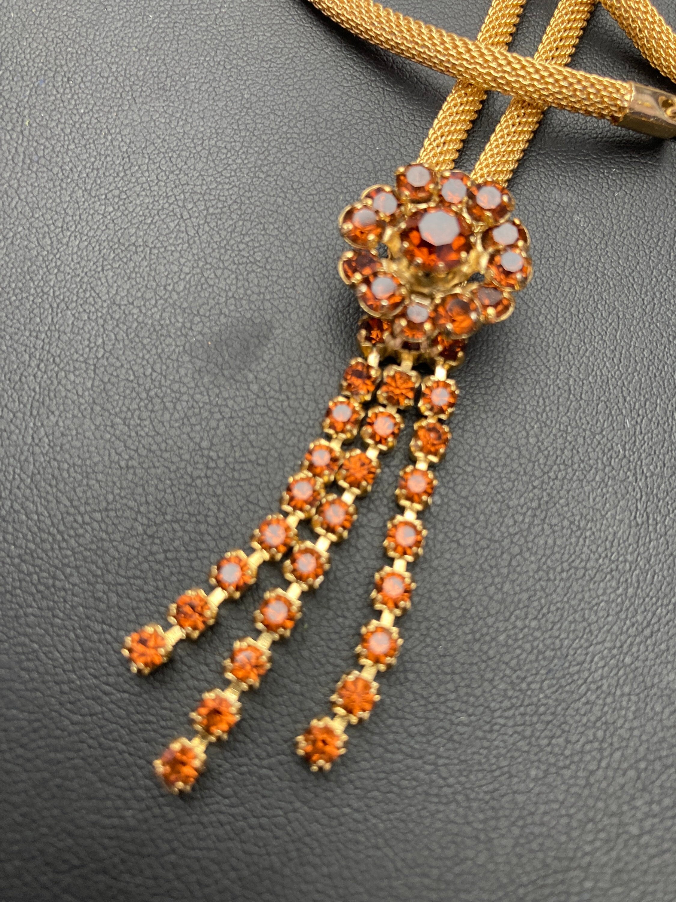 Vintage gold tone mesh lariat drop necklace with brown cognac glass paste stones