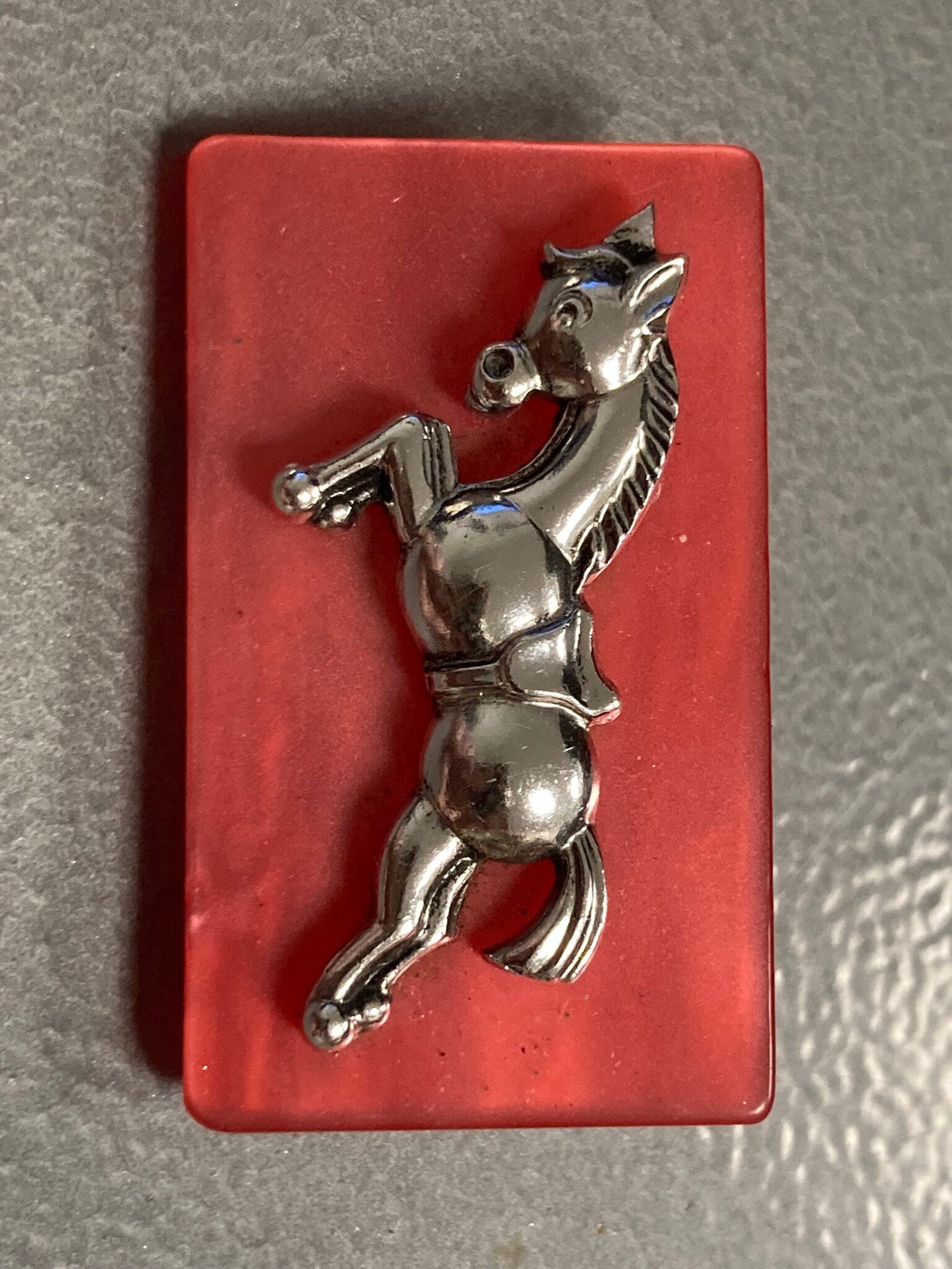 Early Plastic Celluloid Art Deco red resin Silver Horse brooch