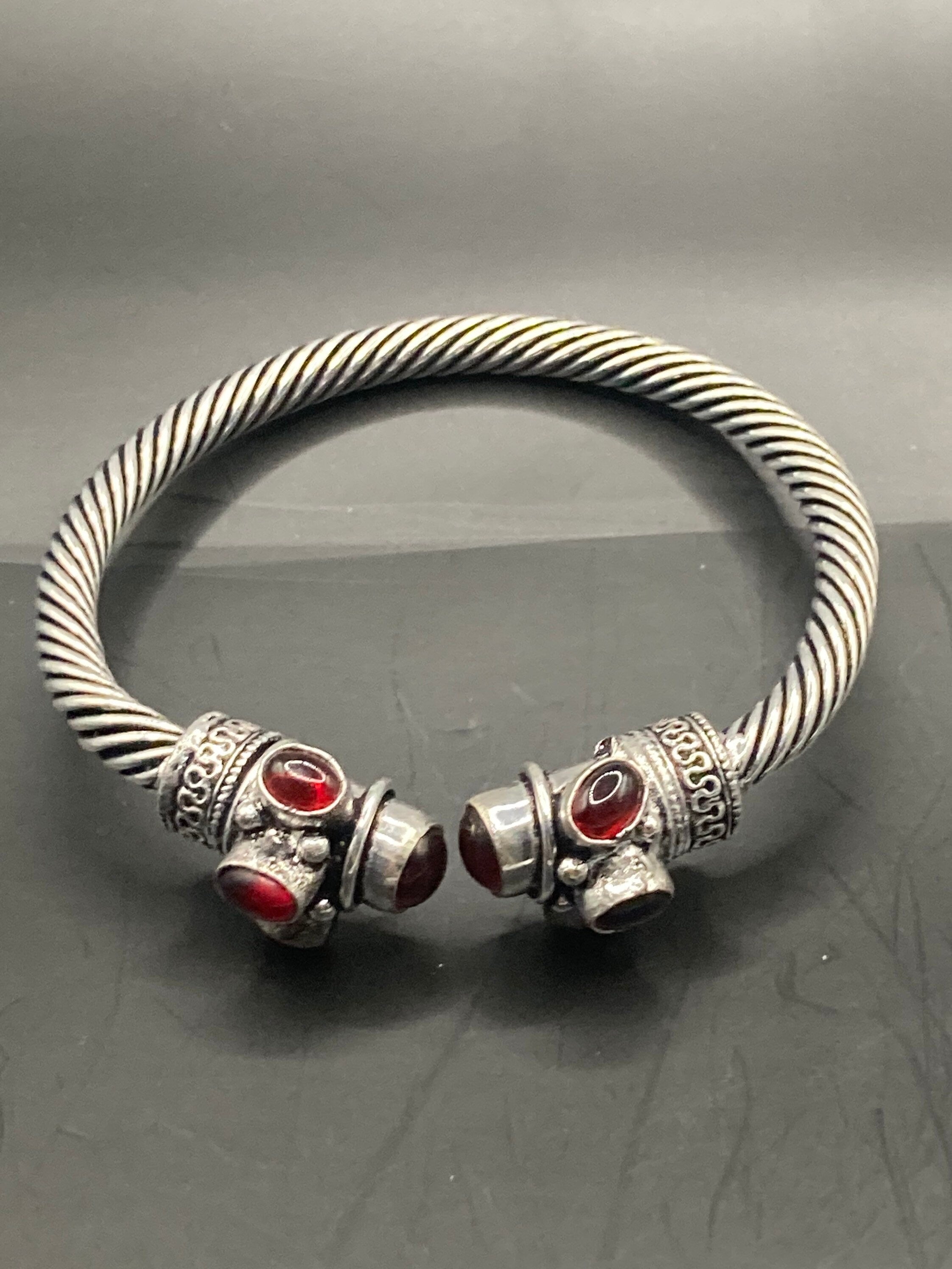 silver tone metal torque cuff bangle bracelet ruby red garnet glass stones