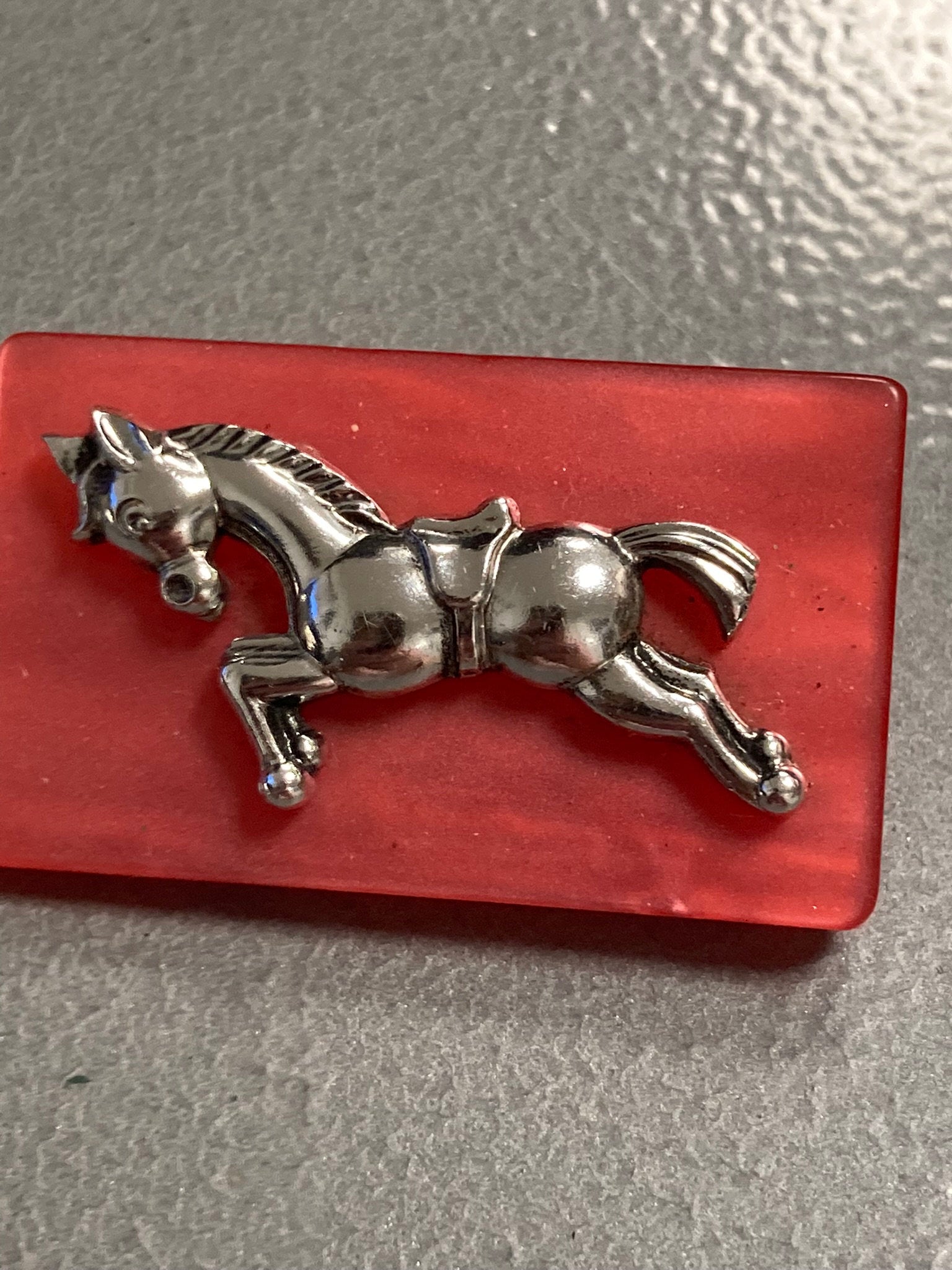 Early Plastic Celluloid Art Deco red resin Silver Horse brooch
