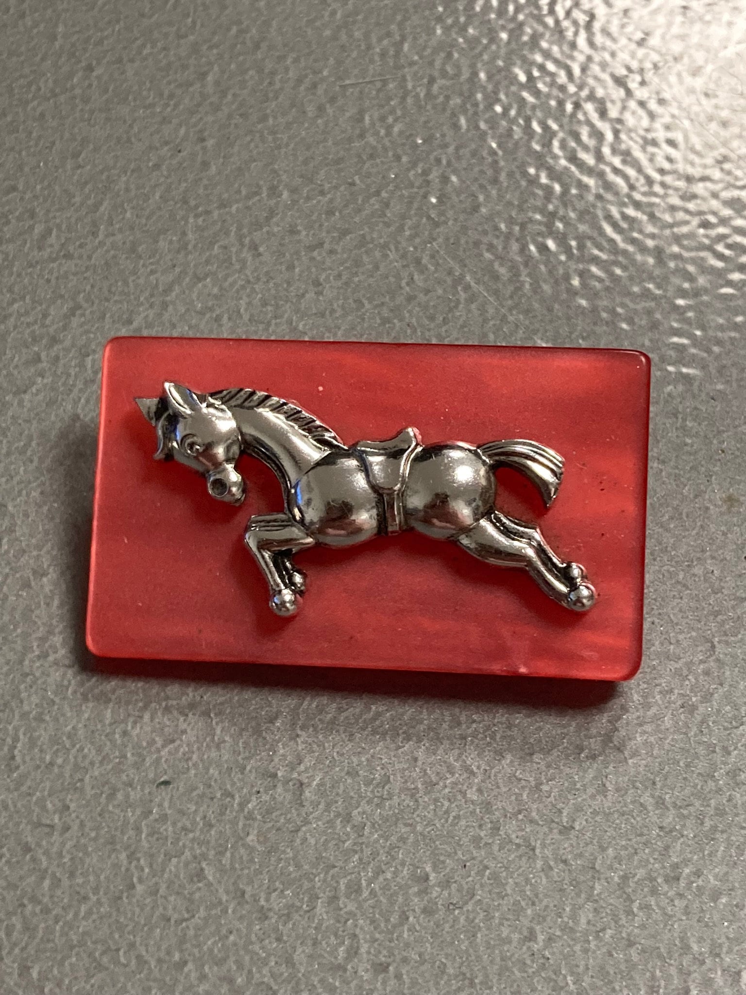 Early Plastic Celluloid Art Deco red resin Silver Horse brooch