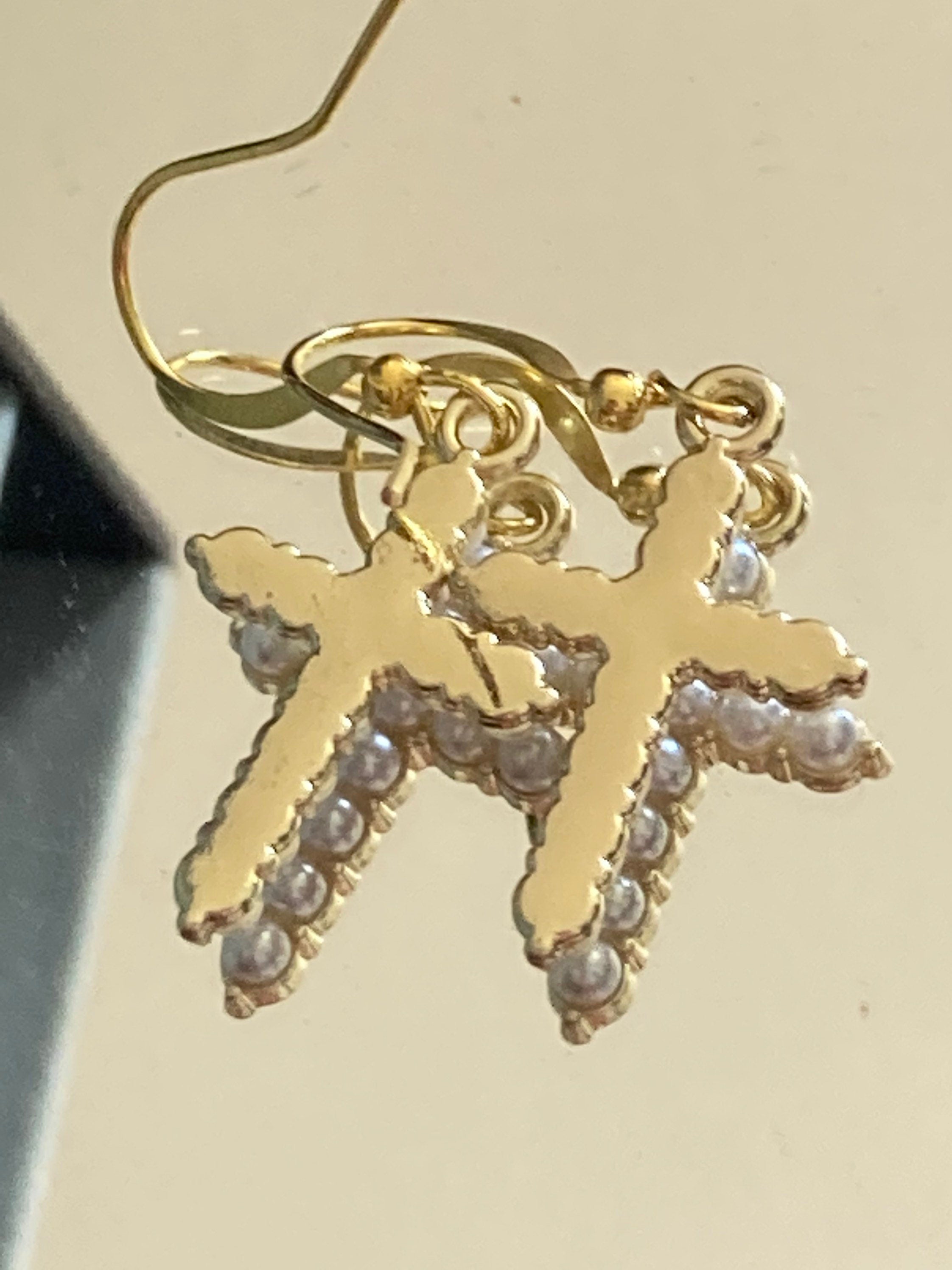 Handmade gold tone white seed Pearl cross drop earrings