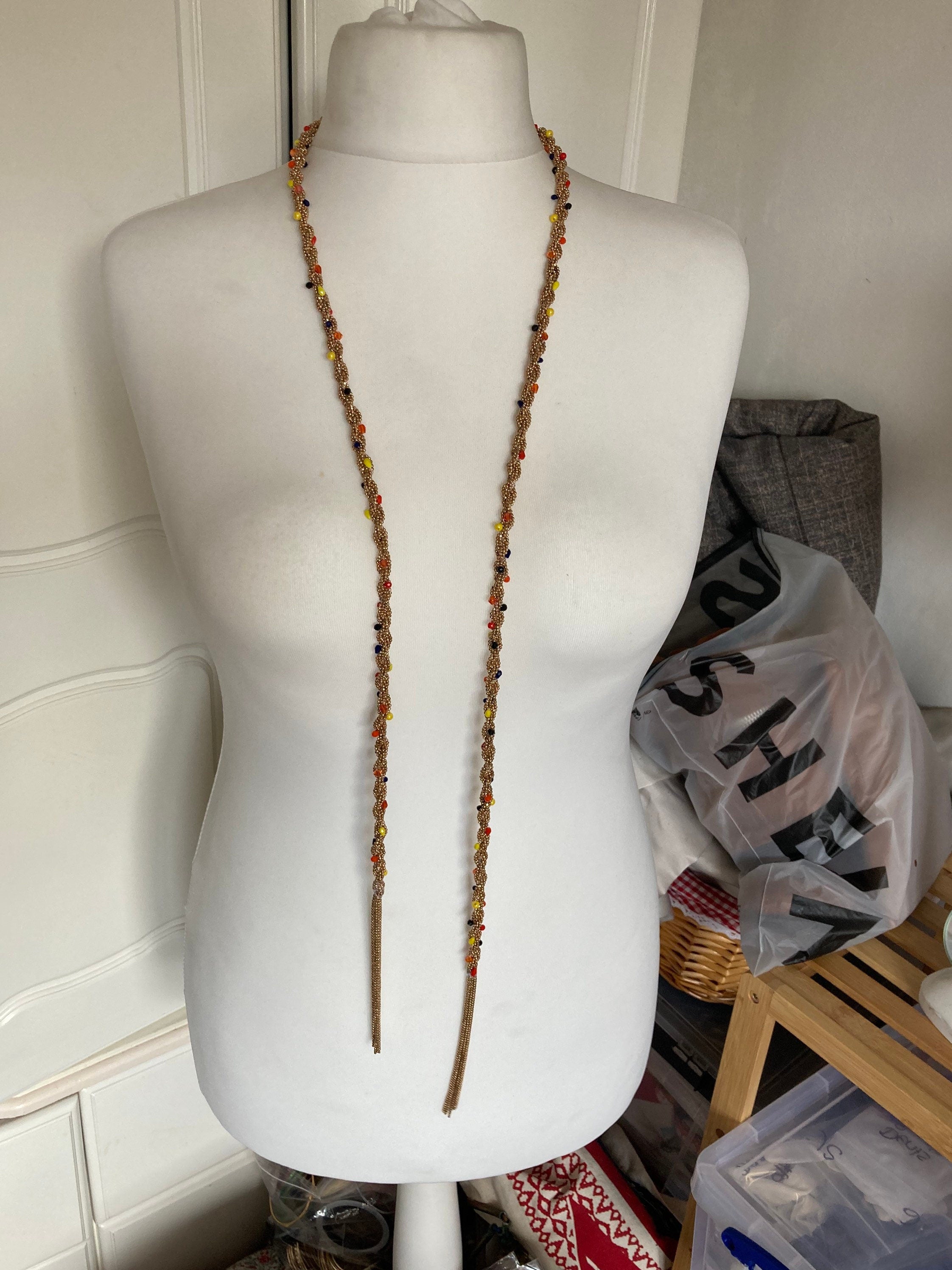 140cm long gold tone tassel necklace with orange yellow woven seed bead flapper length