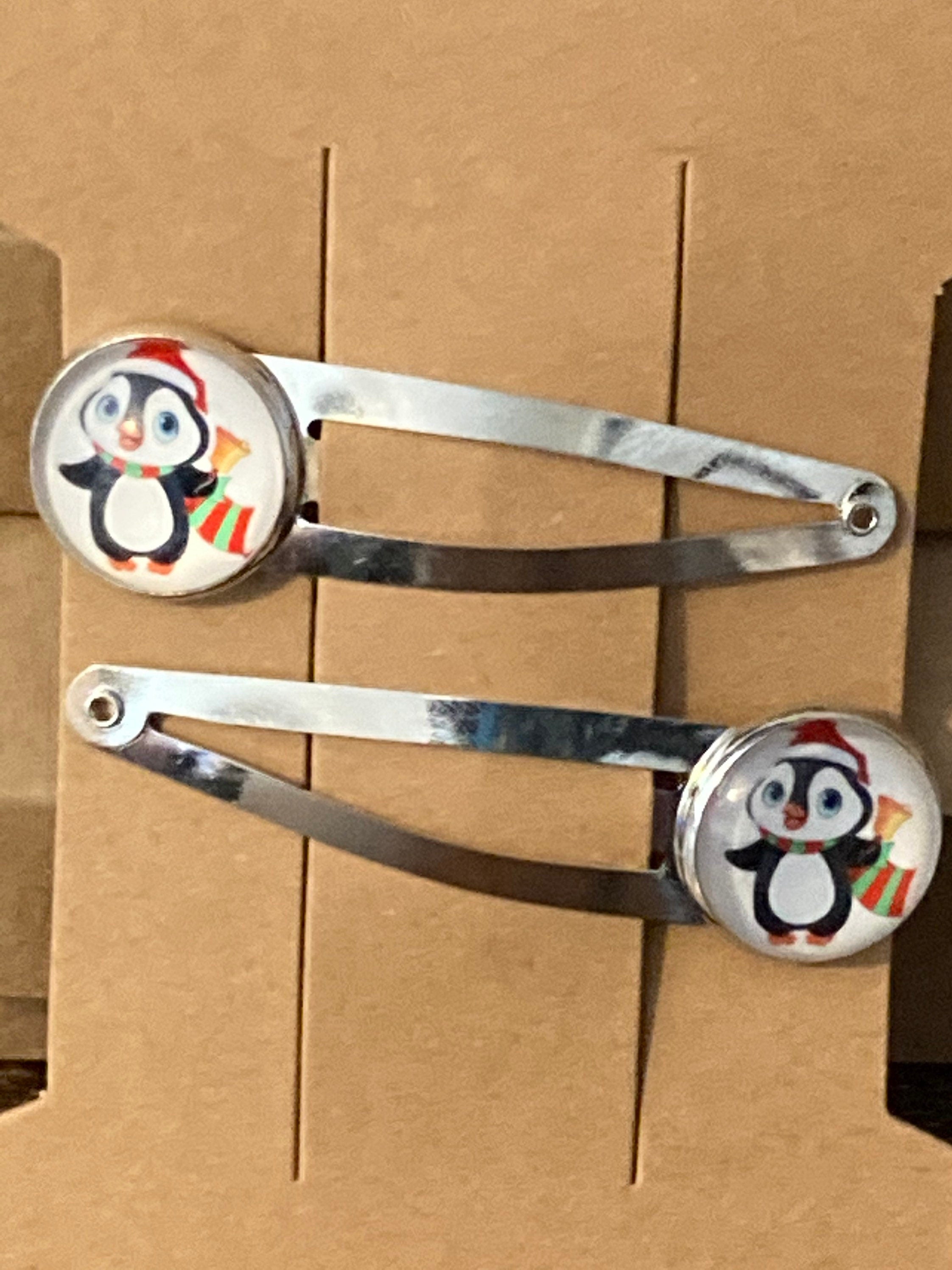 Pair of silver Christmas penguins hair slides