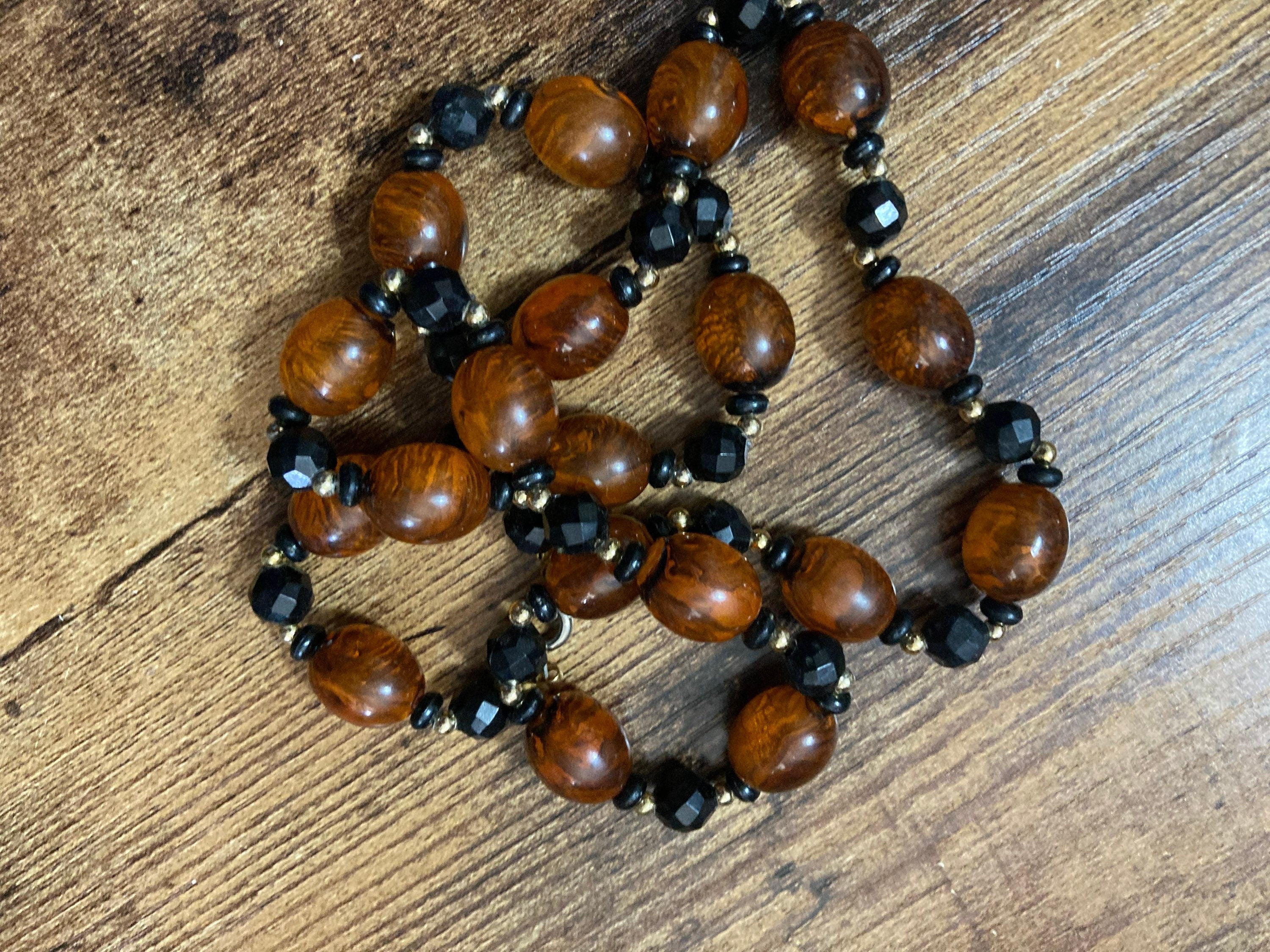 Retro faux amber orange brown  plastic beaded long necklace with black beads