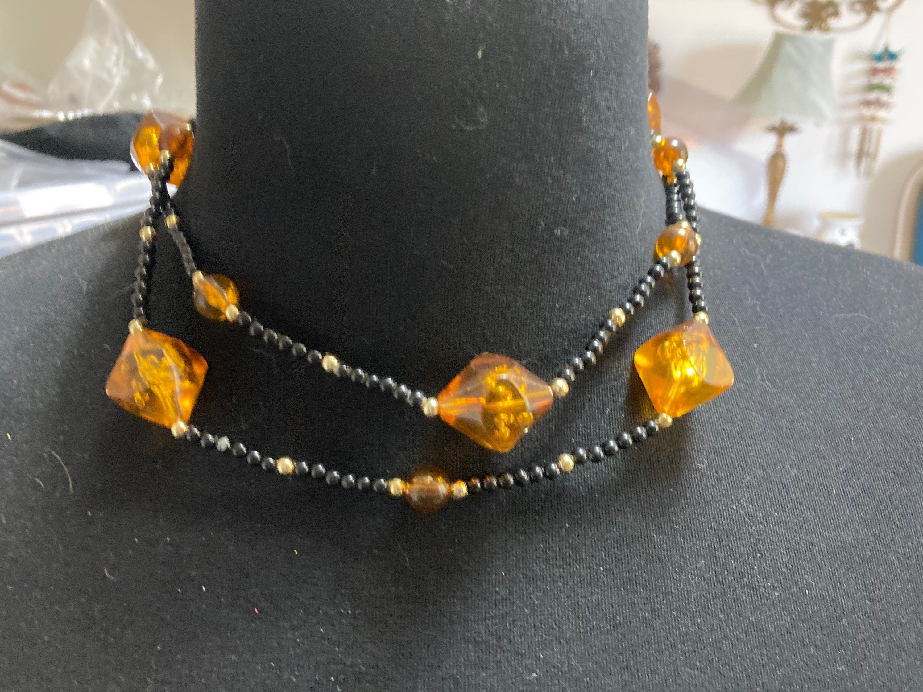 Long faux amber plastic beaded necklace with black gold seed beads 95cm