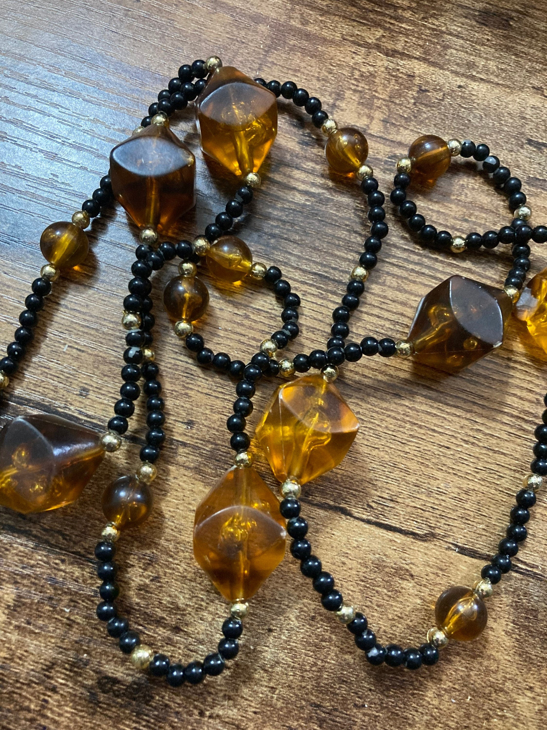 Long faux amber plastic beaded necklace with black gold seed beads 95cm