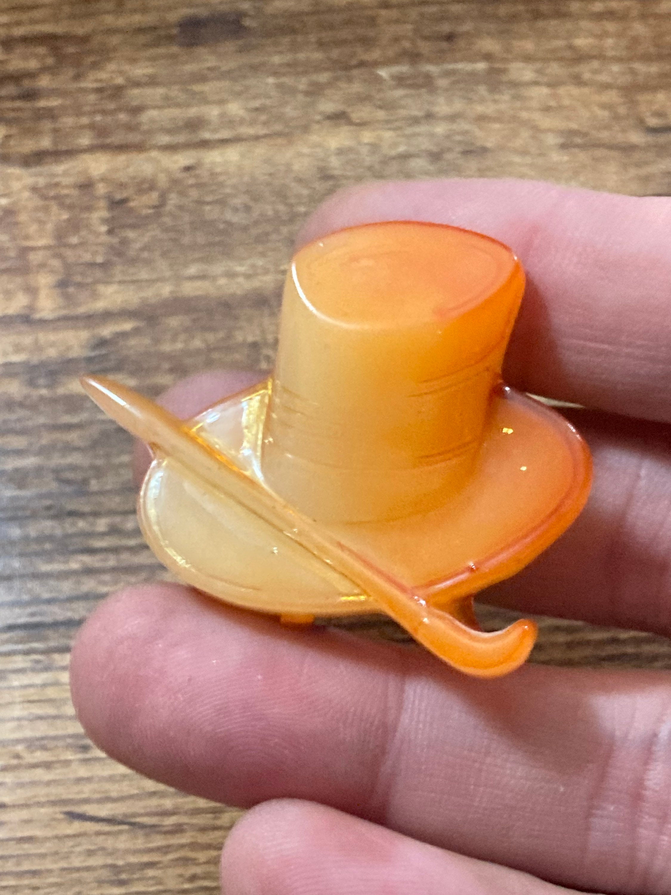 Early Plastic Celluloid Art Deco orange mens top hat and cane brooch