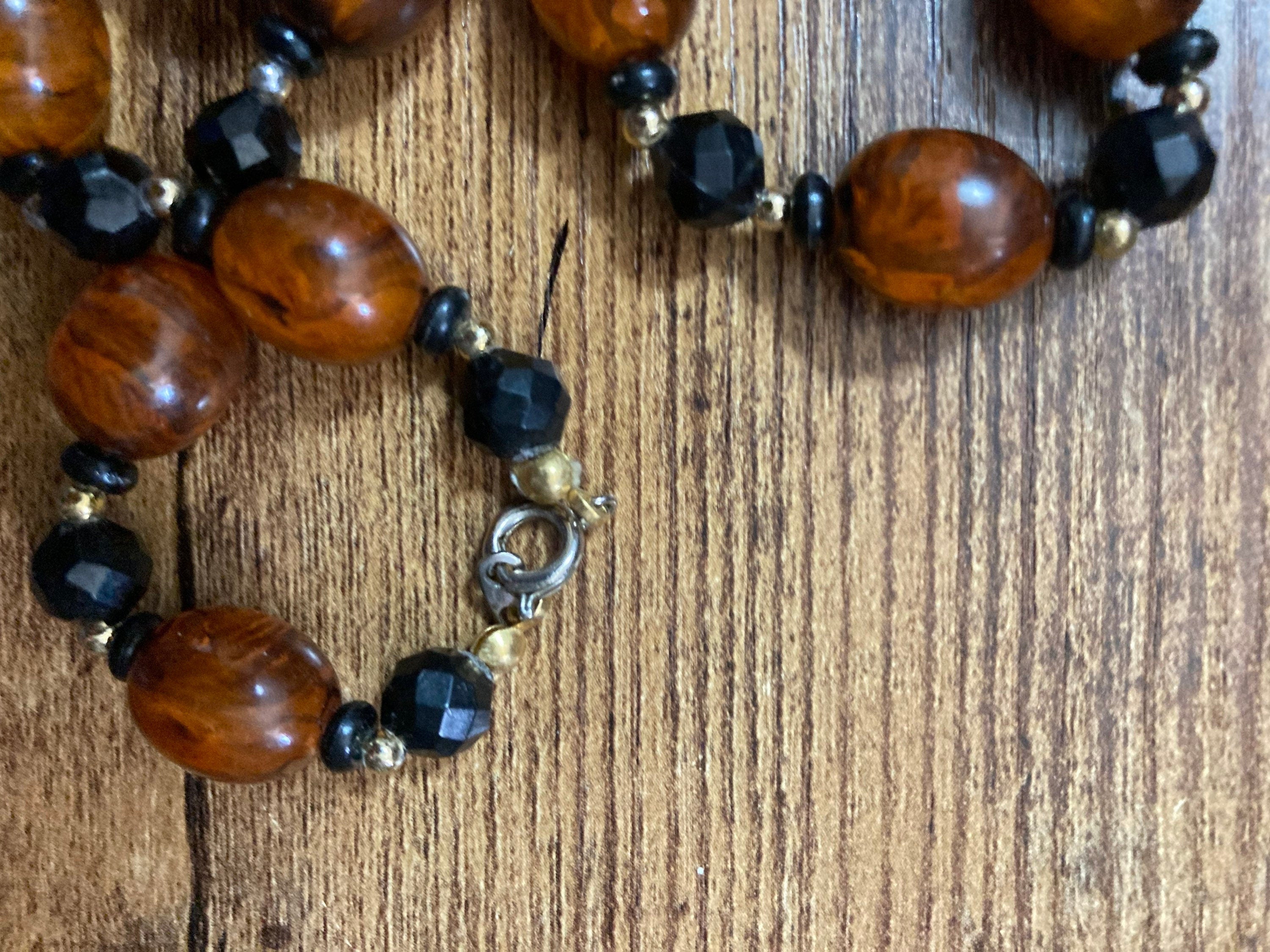 Retro faux amber orange brown  plastic beaded long necklace with black beads