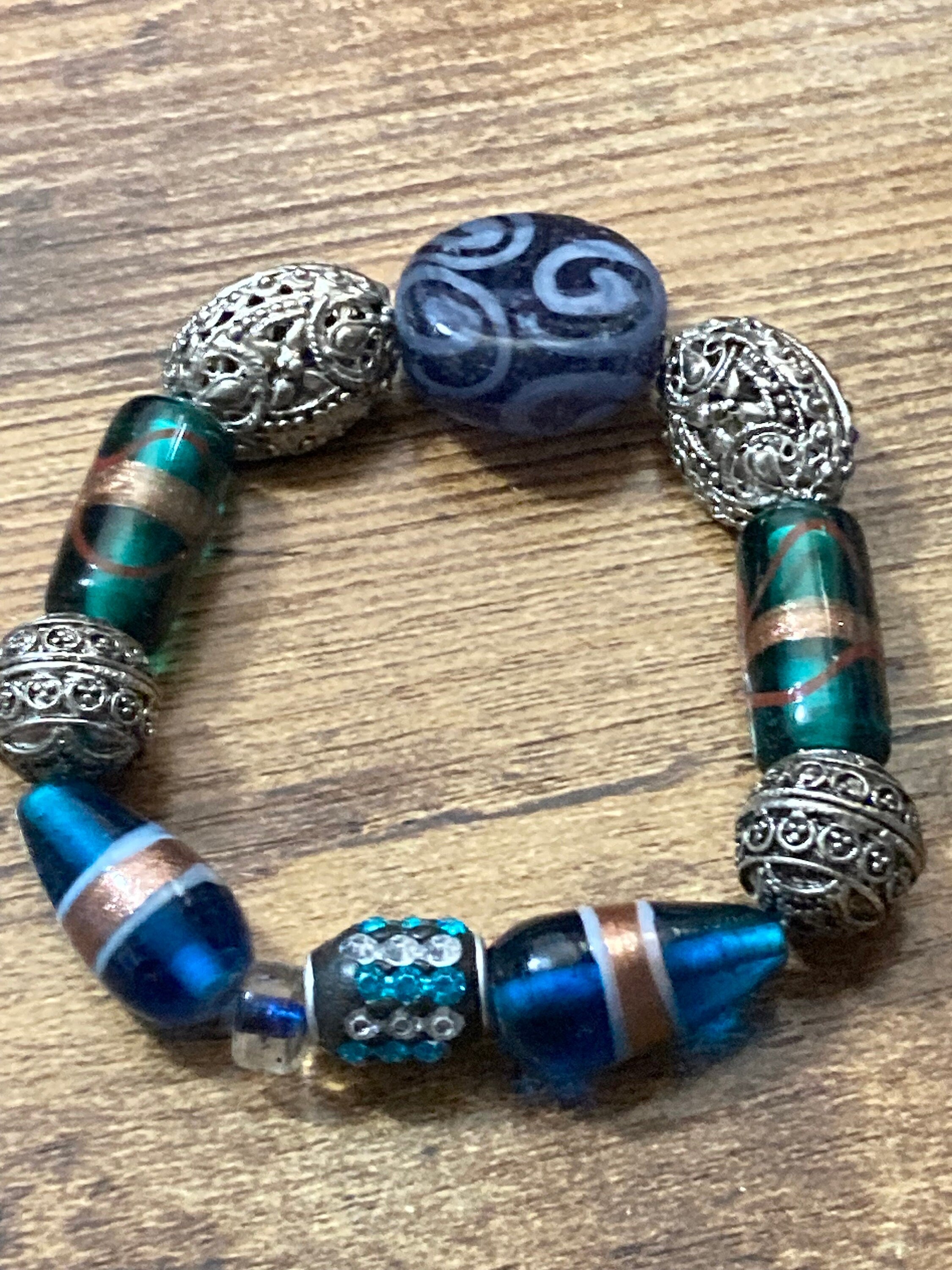 Beautiful blue hues and silver filigree and glass lamp work beaded stretch bracelet perfect for layering